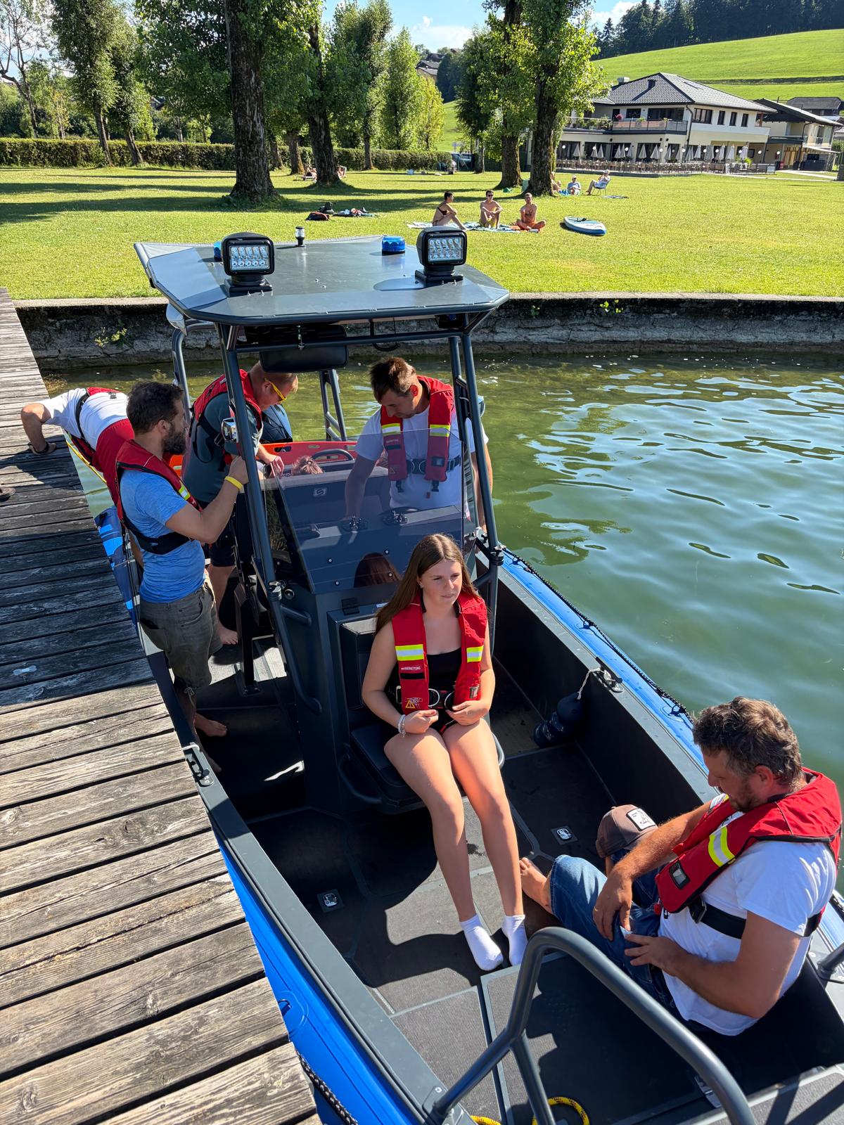 Visitors in life jackets boarding the S585 Pro rescue RIB at the jetty