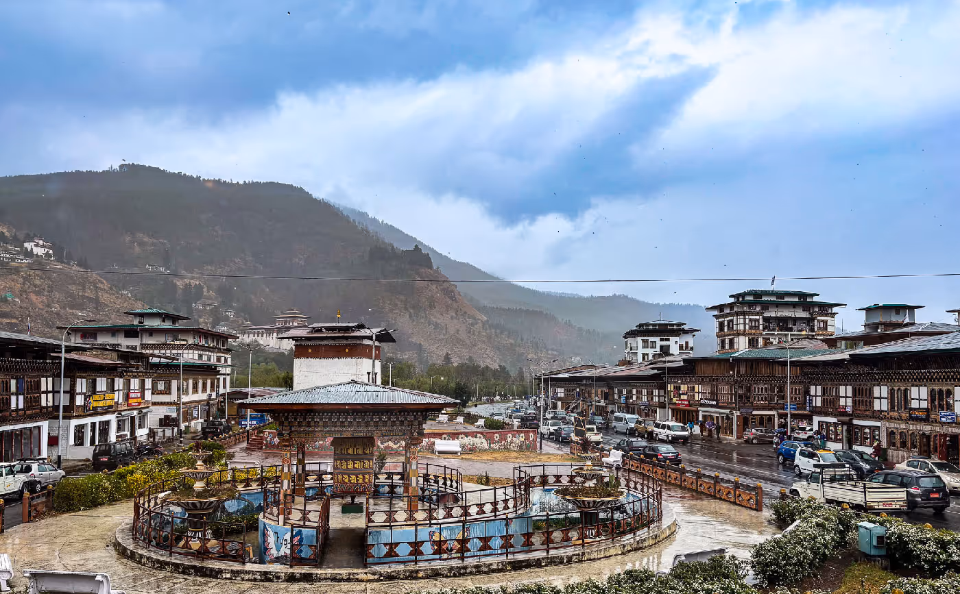 A moody monsoon moment at Paro’s central square, where prayer wheels and traditional buildings meet under a misty blue sky.