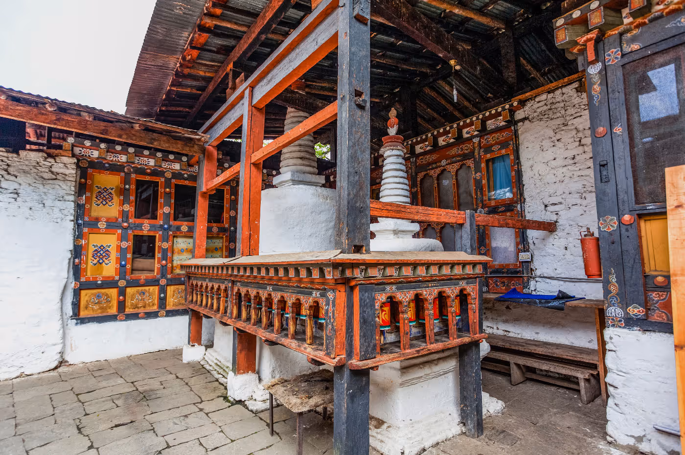 Two ancient stupas in a richly decorated shrine corner of Kyichu Temple, painted in traditional Bhutanese patterns.