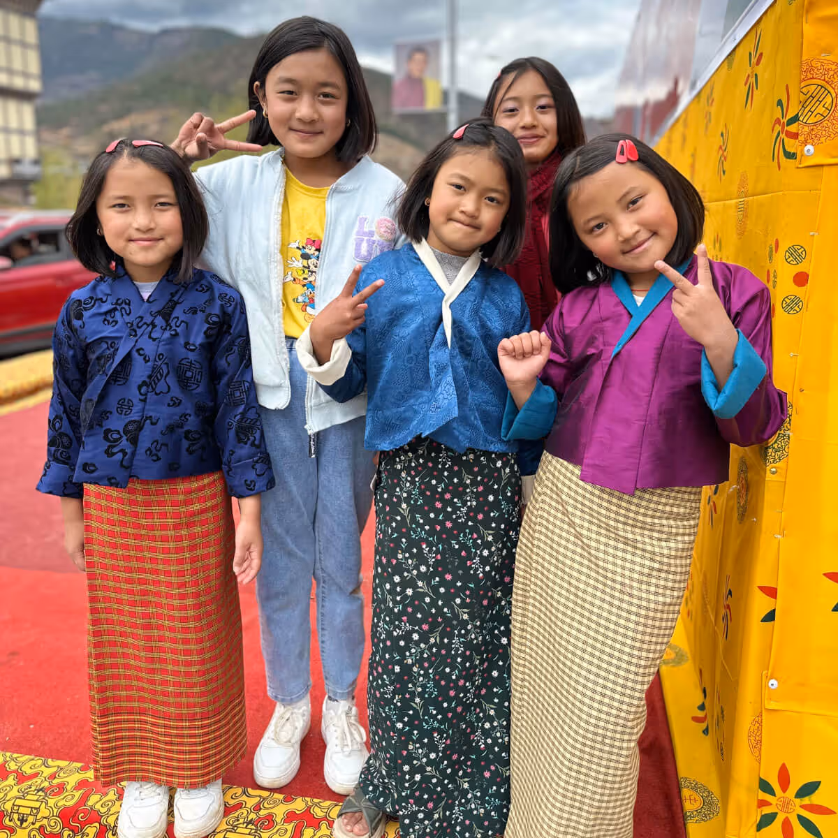 Young Bhutanese girls posing in traditional kira and toego.