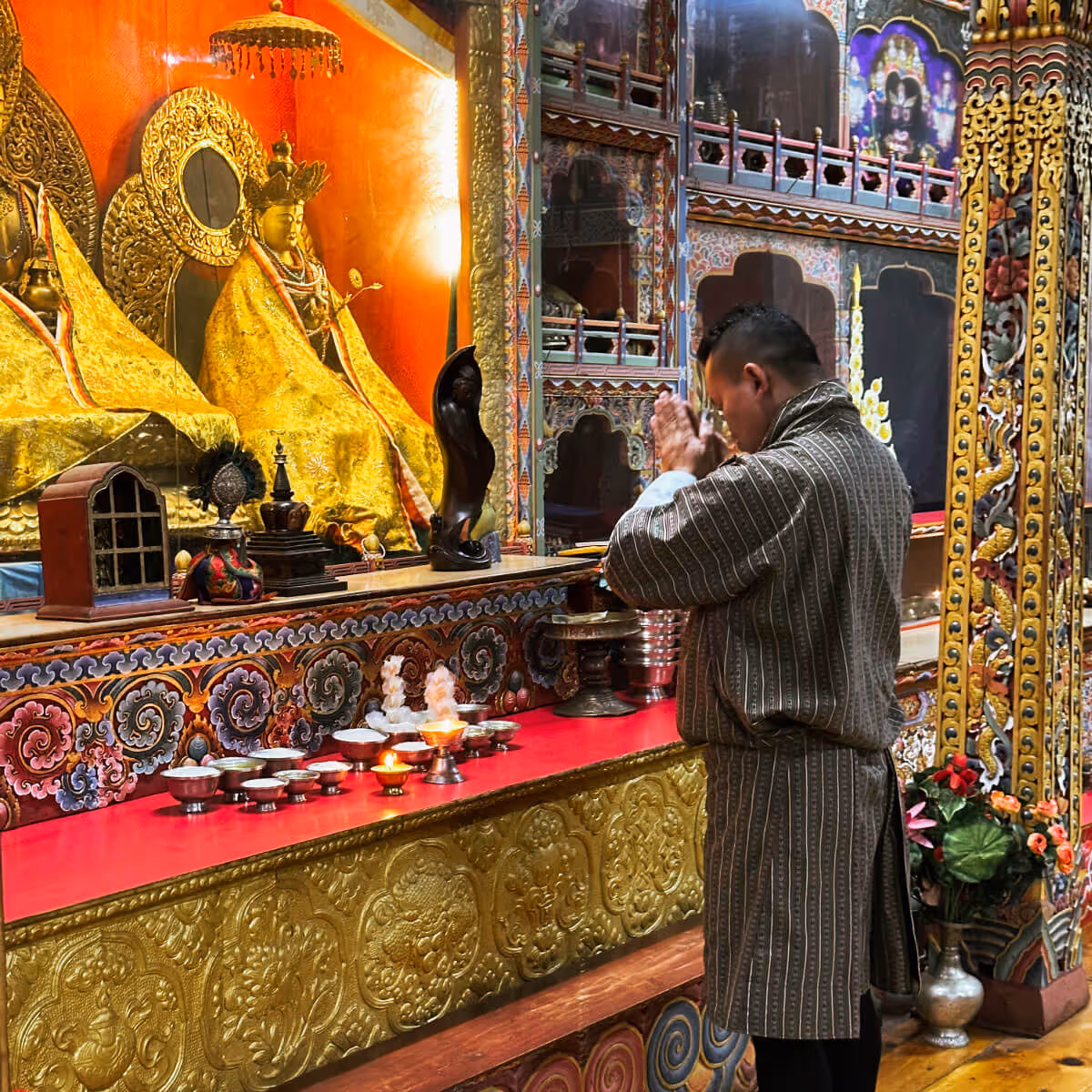 Private prayer offering at a colorful shrine in Bhutan