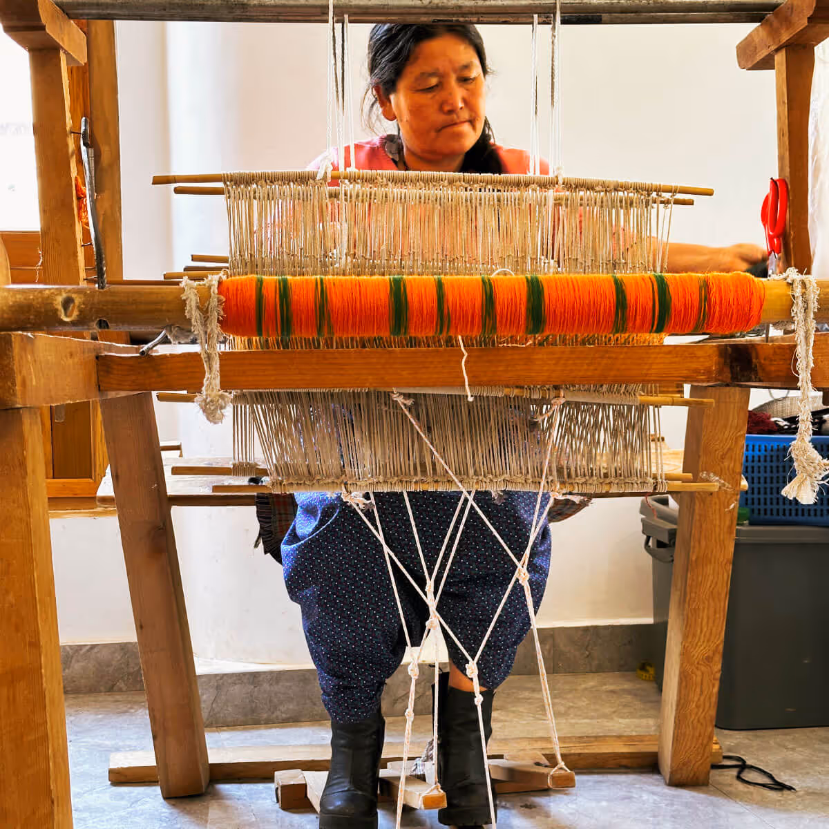 Woman weaving on a traditional loom in Bhutan