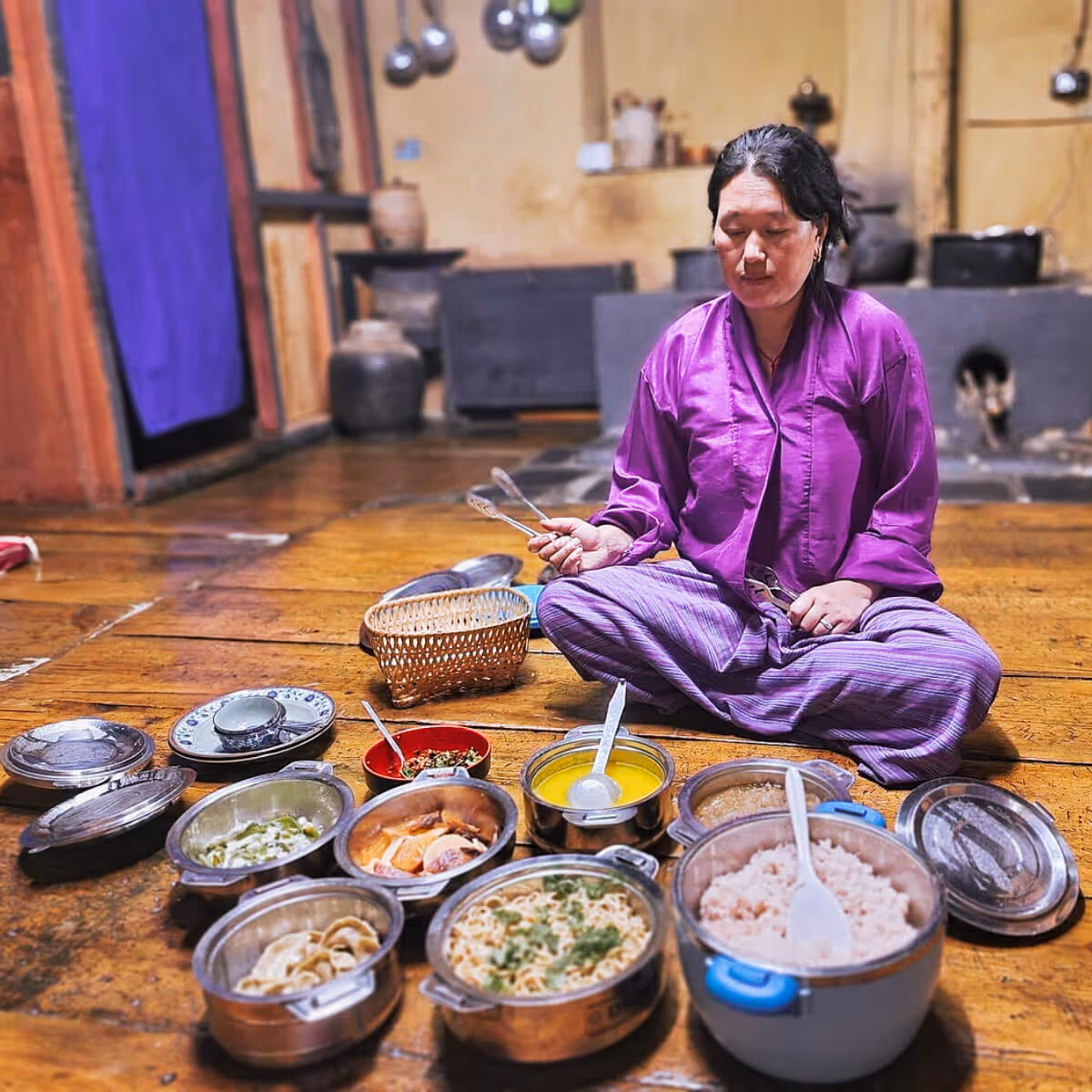 Bhutanese woman preparing traditional farmhouse meal.