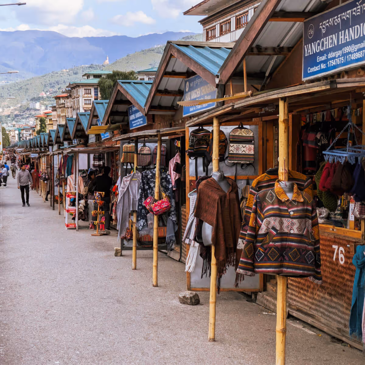 Traditional craft stalls at the Authentic Craft Bazaar in Thimphu, lined with colorful textiles, bags, and local handicrafts.