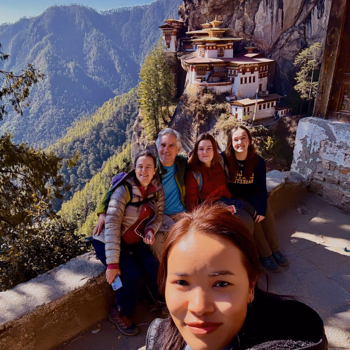 Guide taking a selfie with happy guests at Tiger’s Nest Monastery in Paro, Bhutan.