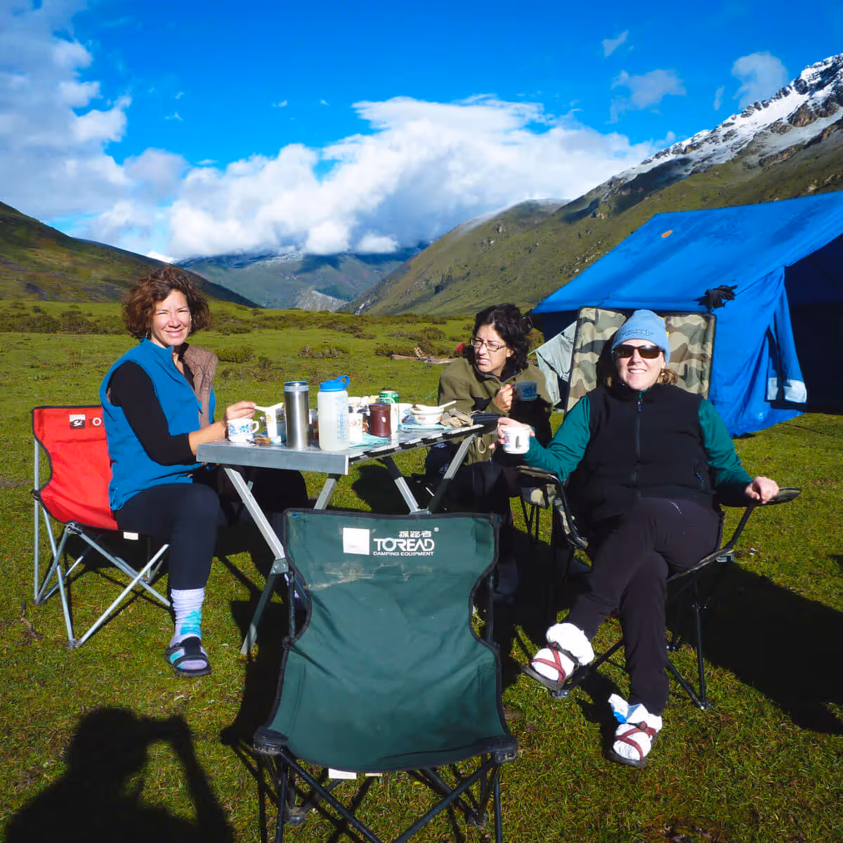 Travelers enjoying breakfast with mountain views during the Nub Tshonapata Trek in Bhutan.