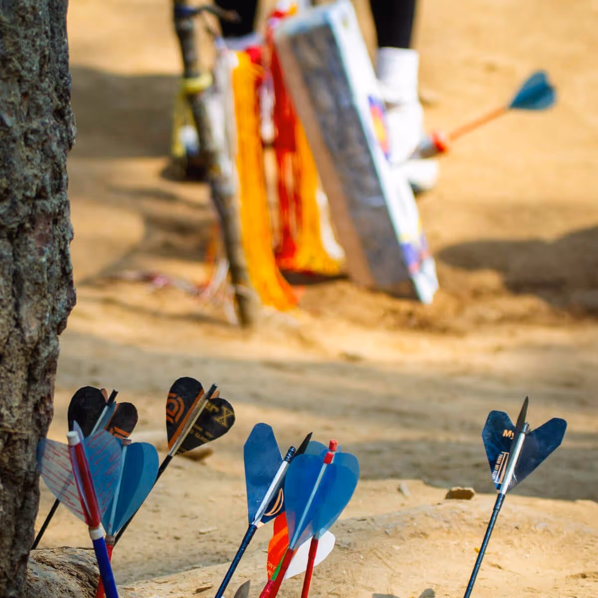 Colorful darts with one hitting the bullseye on a traditional Bhutanese target.