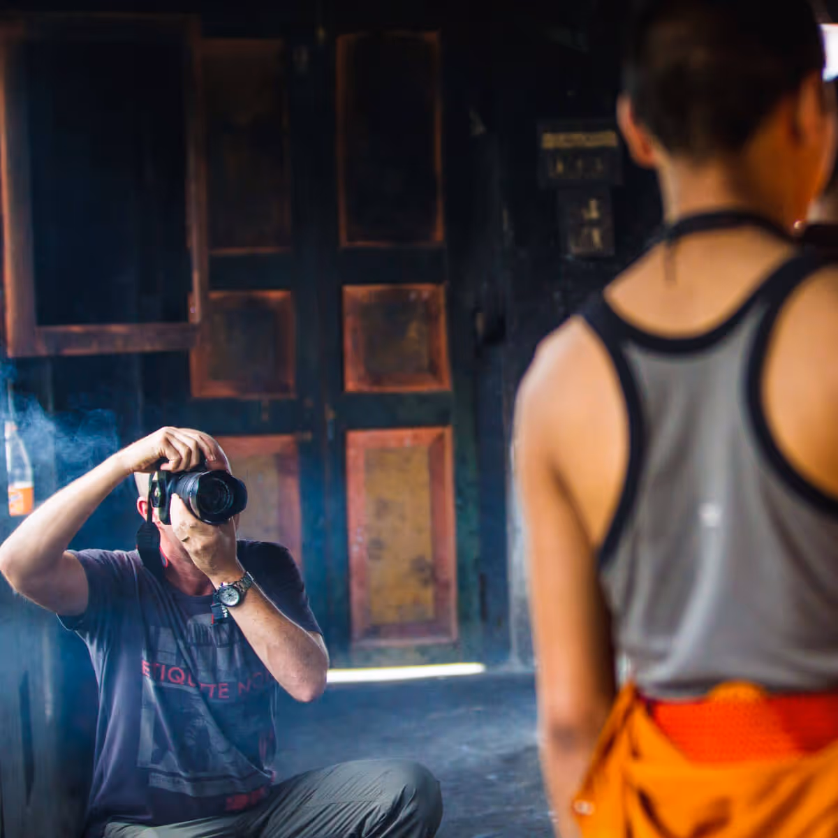 Guest photographing a monk inside a Bhutanese home
