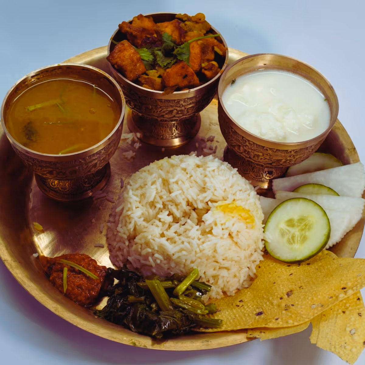 Traditional Nepali thali meal with rice, curry, and yogurt