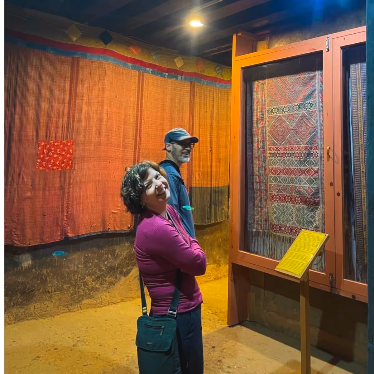 Guests admiring traditional Bhutanese textile exhibits inside Wangdicholing Palace in Bumthang, Bhutan.