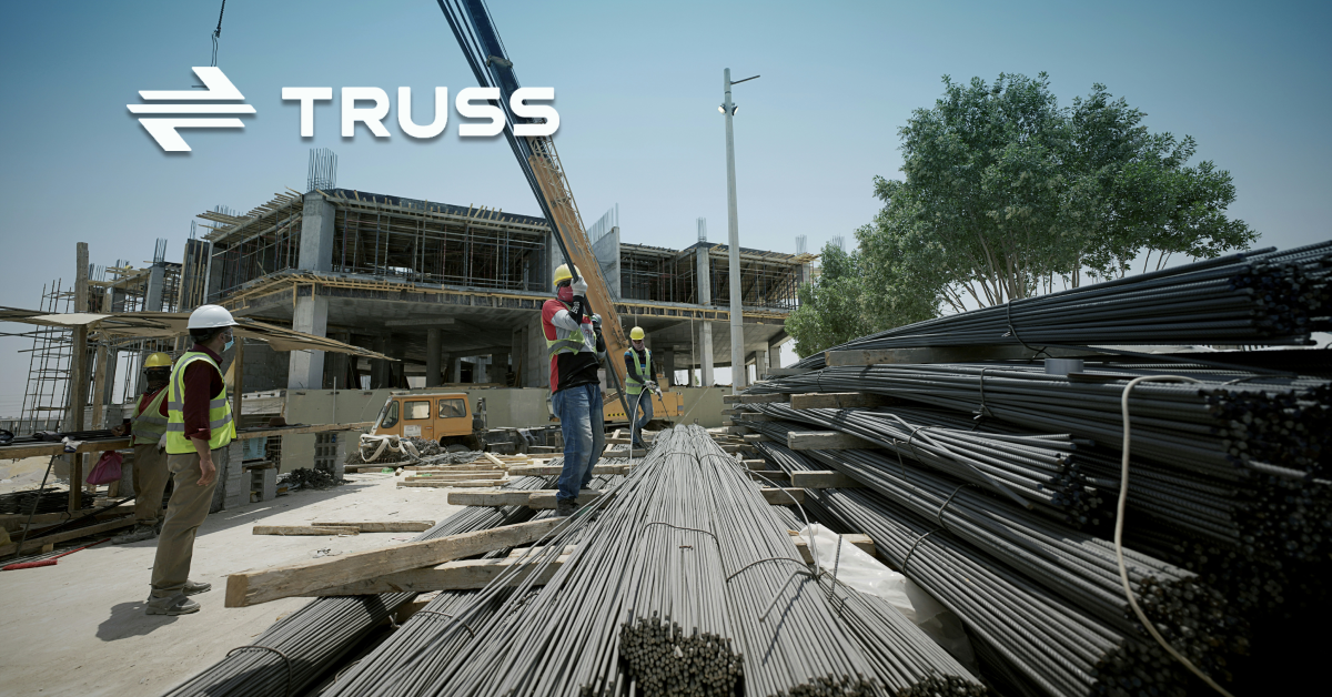 Construction workers managing rebar on a building site, representing how SAʴý job cost accounting software helps contractors track expenses and stay on budget.