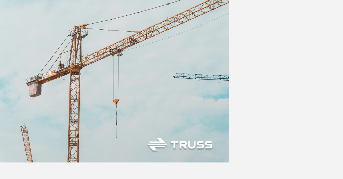 Construction cranes against a clear sky representing centralized treasury and multi-project cash management for contractors using 91vlog Payments.