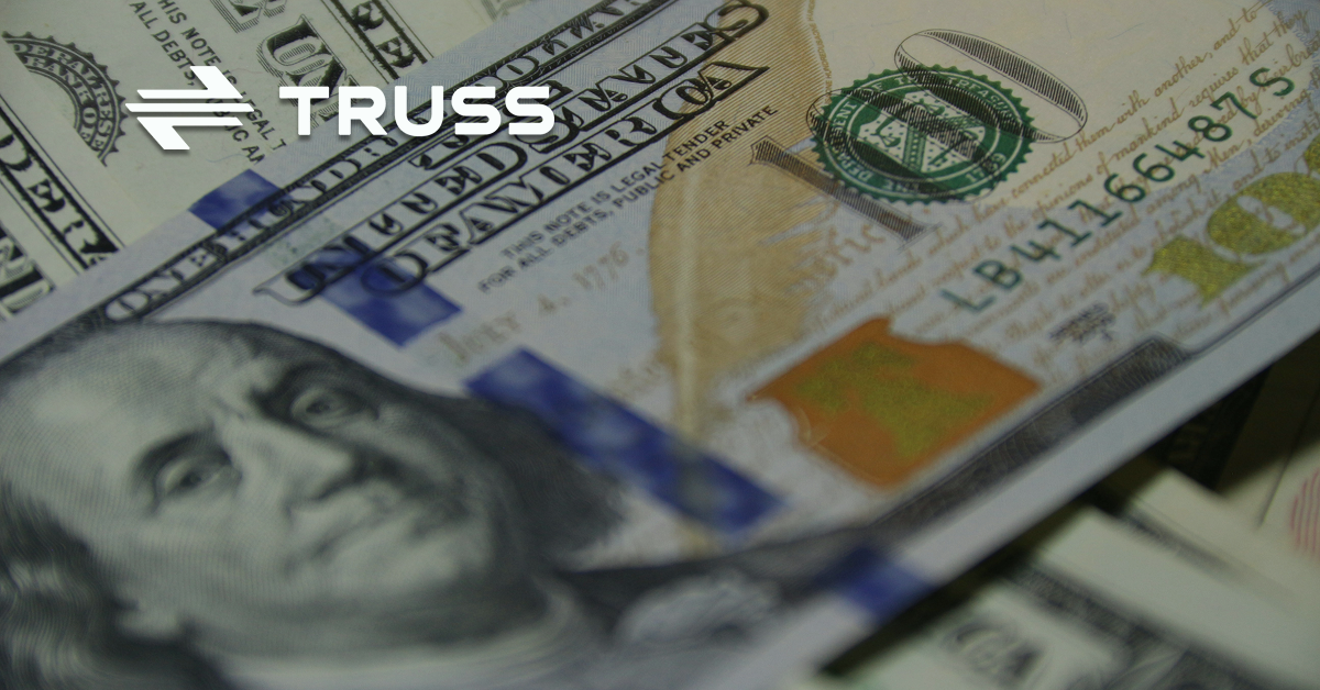 Close-up of U.S. hundred-dollar bills representing contractor cash flow management and financial stability in construction projects.