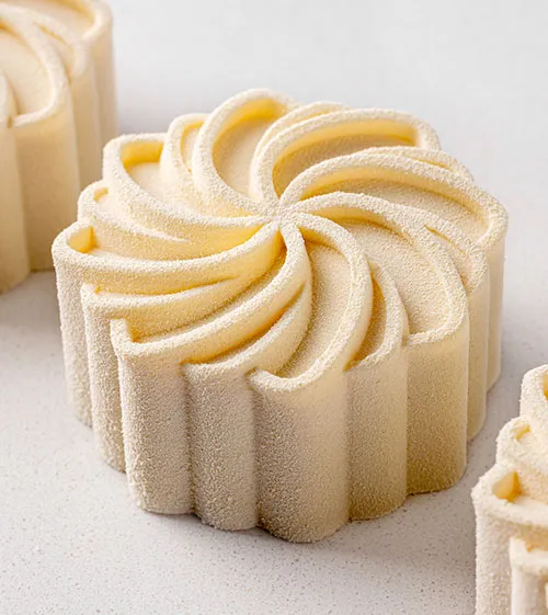 A pastry with a swirl pattern on top. Nicolas Rouzaud - Maison de Haute Patisserie creation