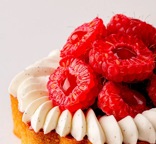 A slice of cake with red raspberries on top. Nicolas Rouzaud
Maison de Haute Patisserie creation
