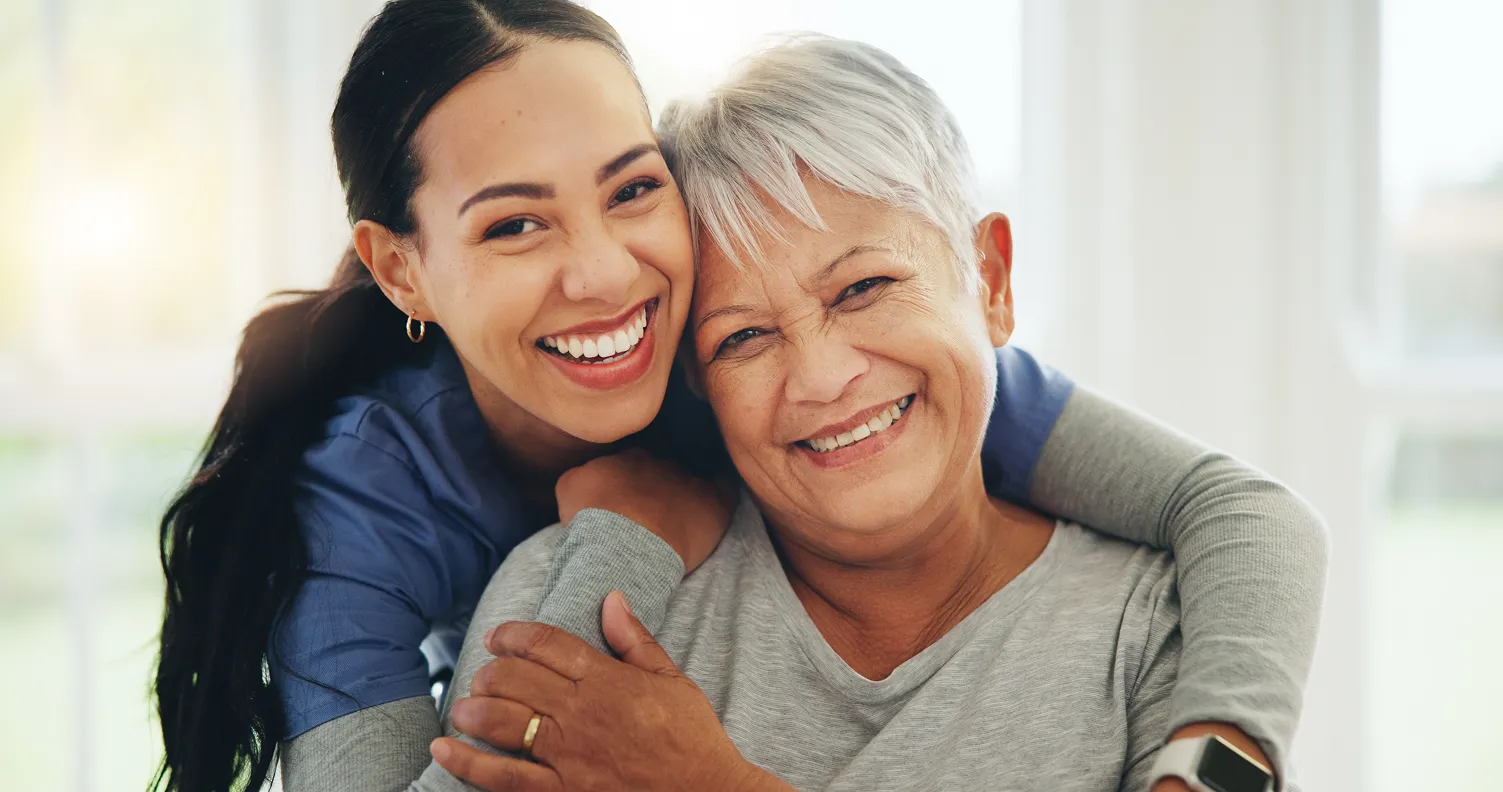 A woman and her care taker smiling