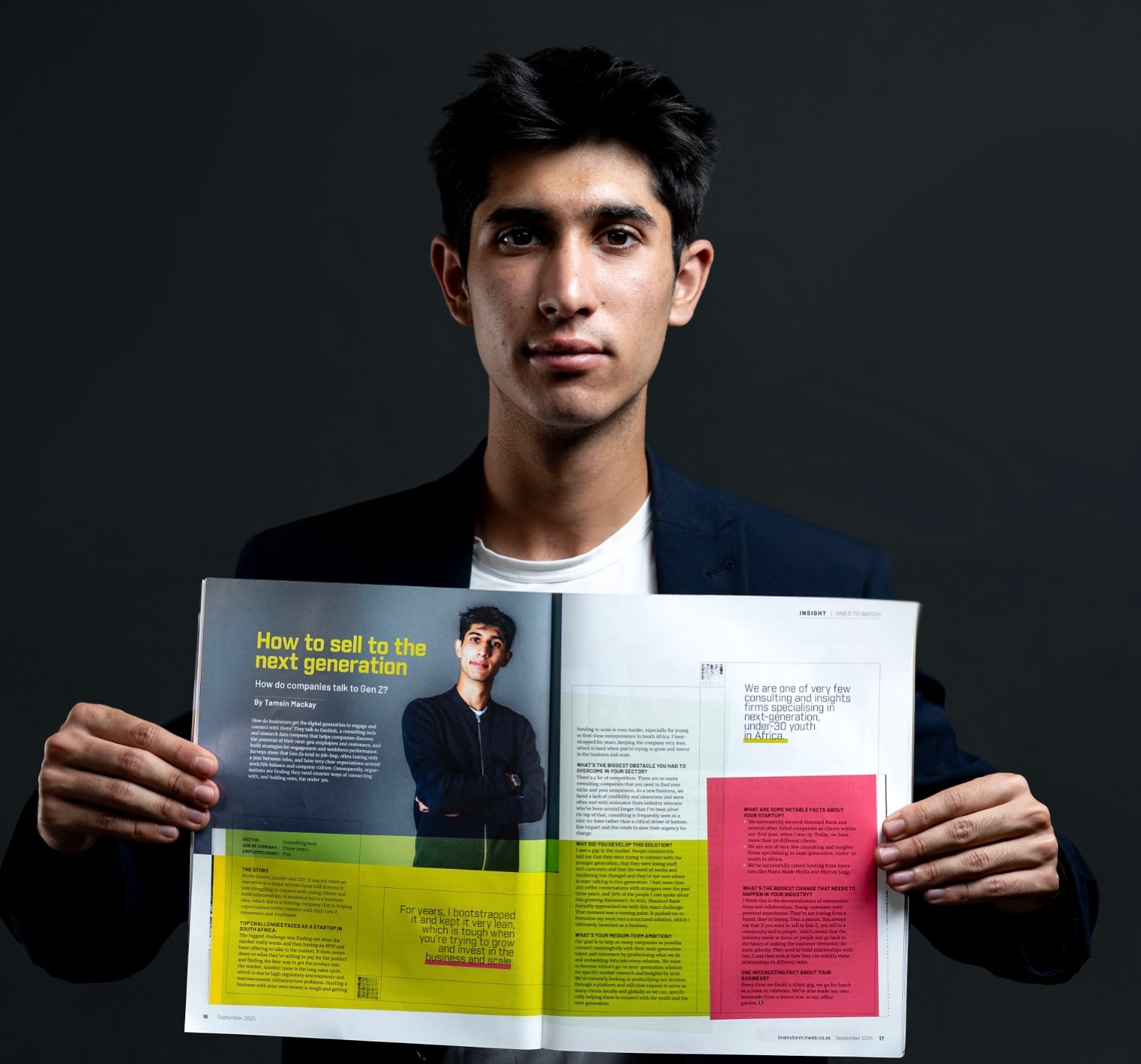 Young man in blazer holding open magazine featuring article on selling to next generation.