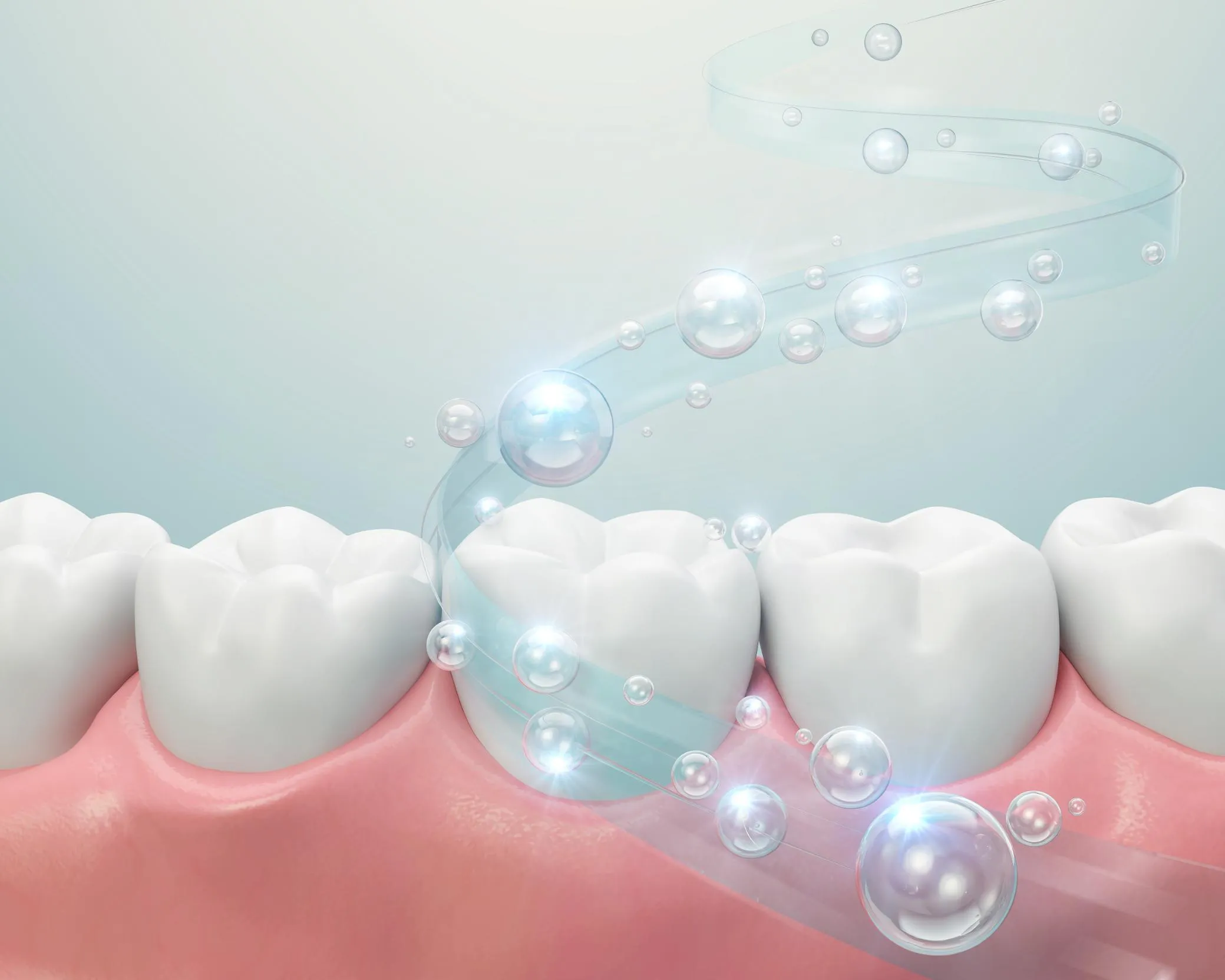Close-up illustration of clean white molars with sparkling bubbles and a swirl representing freshness and dental hygiene.