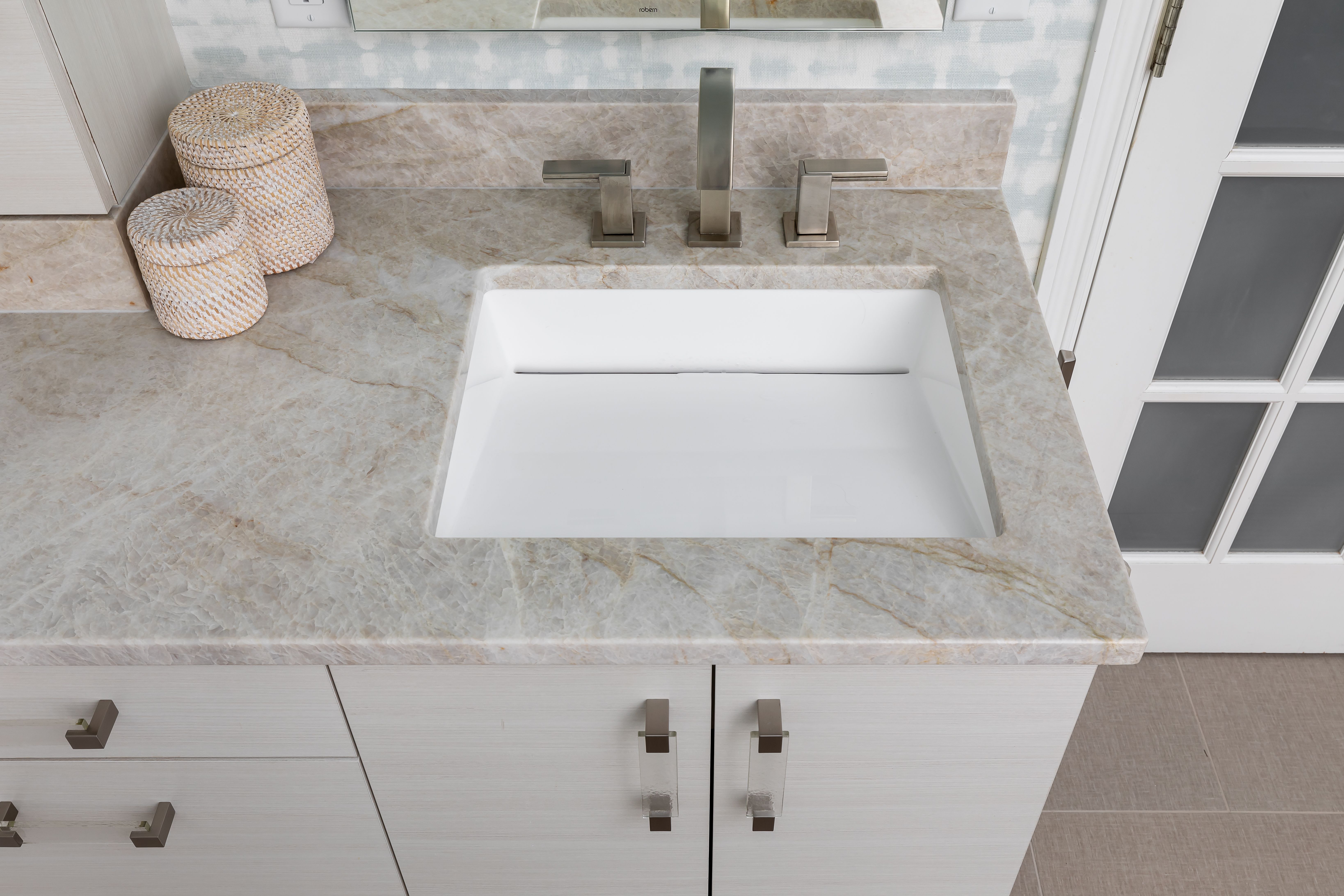 A spa-inspired primary bath remodel in Bellevue, WA — his-and-hers vanity, improved storage, and a calming palette of watery textures and motifs.
