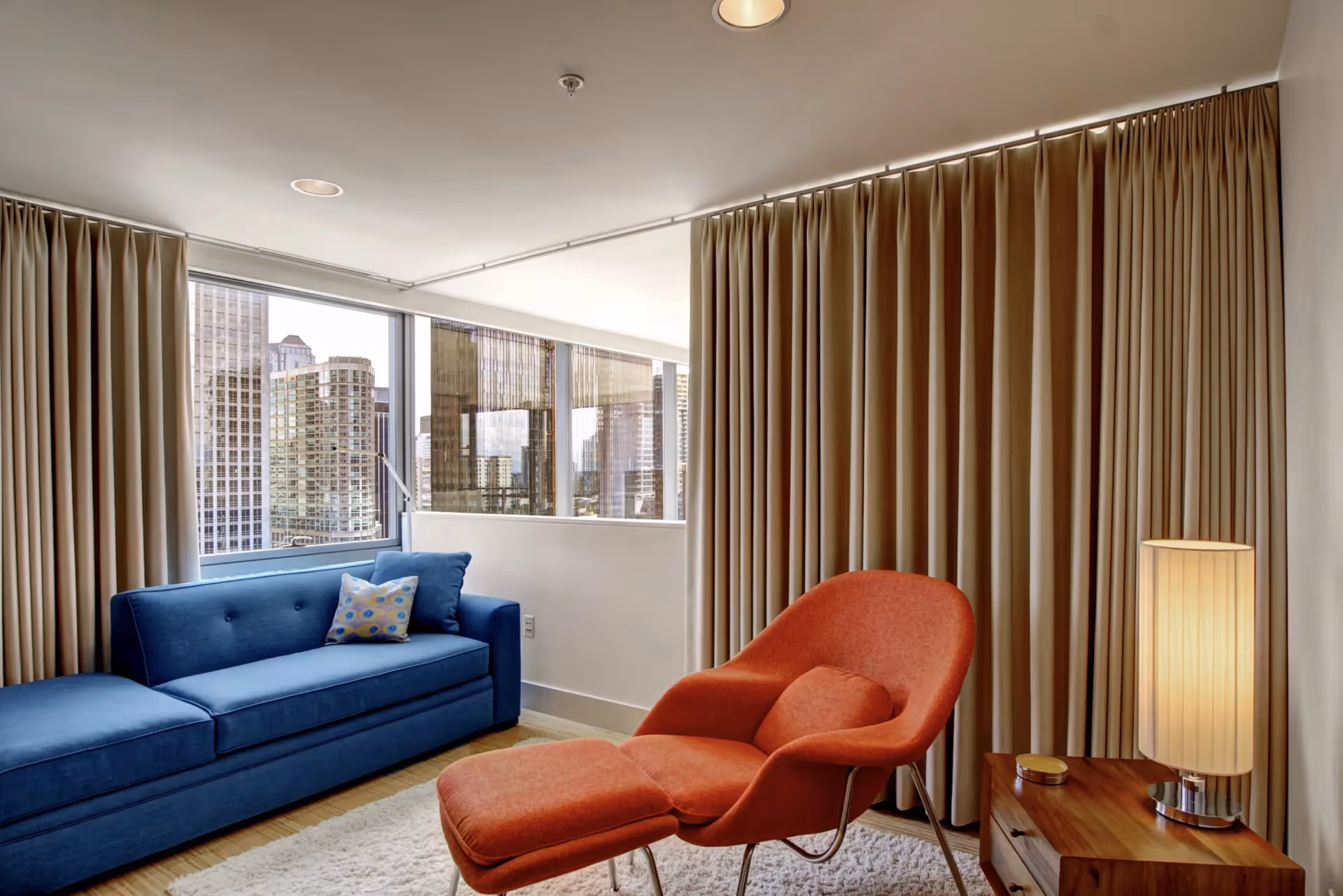 A bedroom redesign in Seattle's Laurelhurst neighborhood — jewel tones, sisal wallpaper, cut velvet, and a dramatic chandelier anchored by curated art.