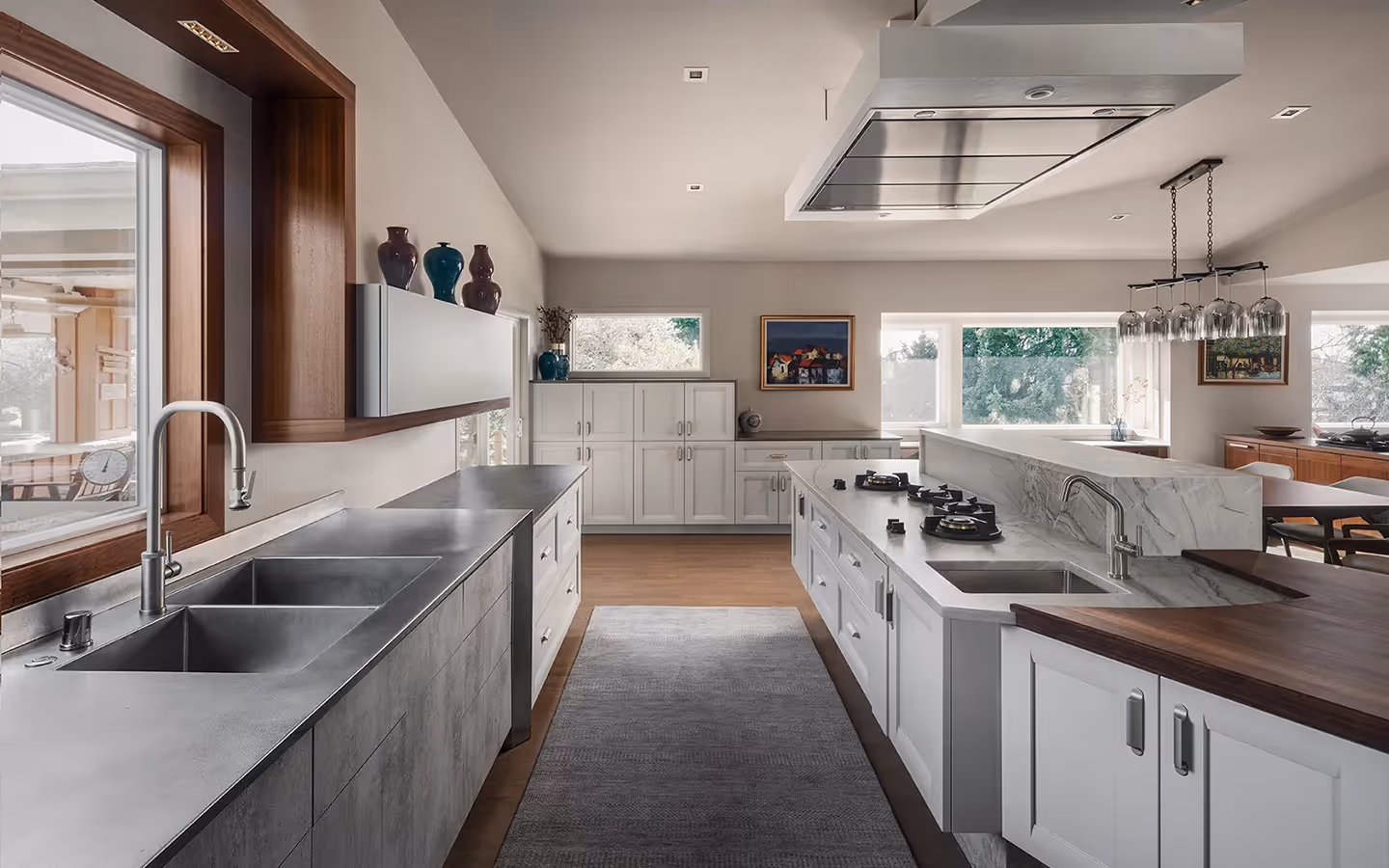 NKBA First Place winner for Open Plan Kitchen — a shimmering contemporary remodel in Bellevue featuring quartzite, African mahogany, and hidden appliances.