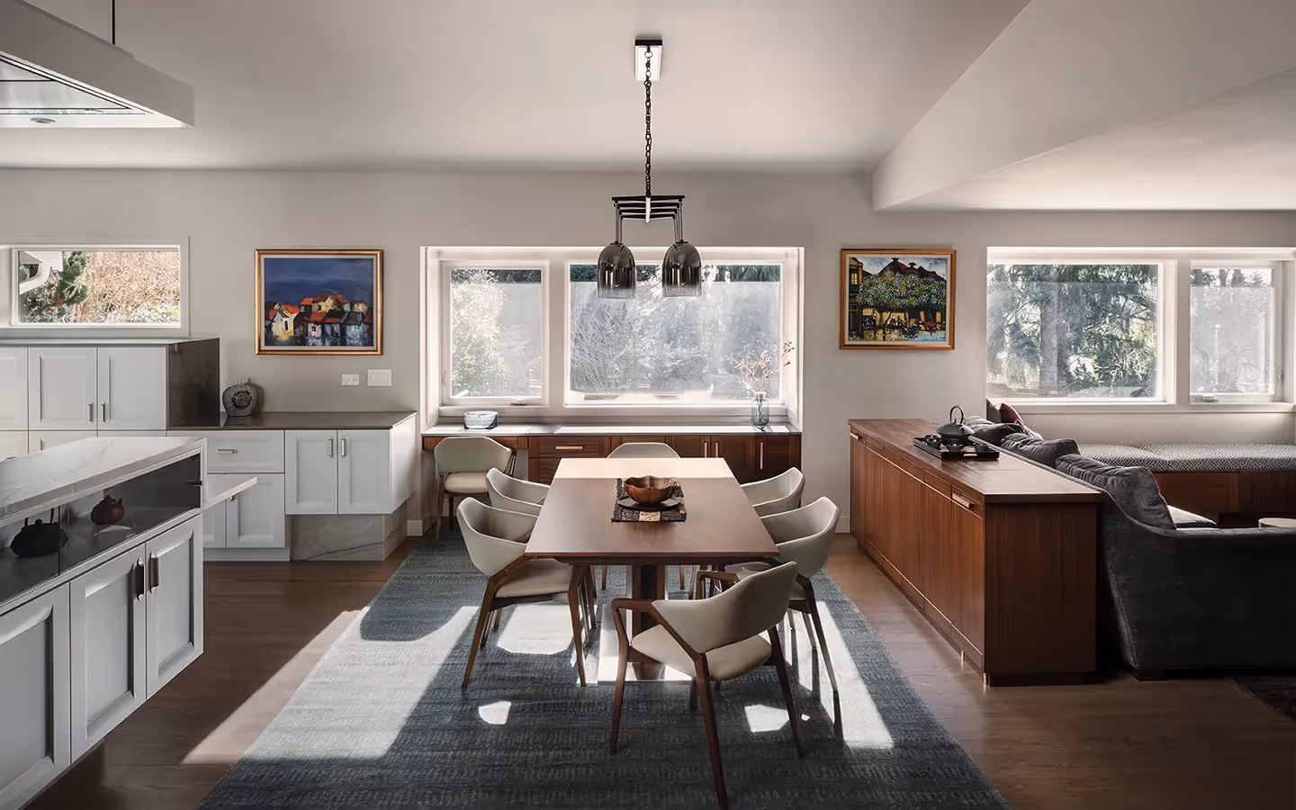 NKBA First Place winner for Open Plan Kitchen — a shimmering contemporary remodel in Bellevue featuring quartzite, African mahogany, and hidden appliances.