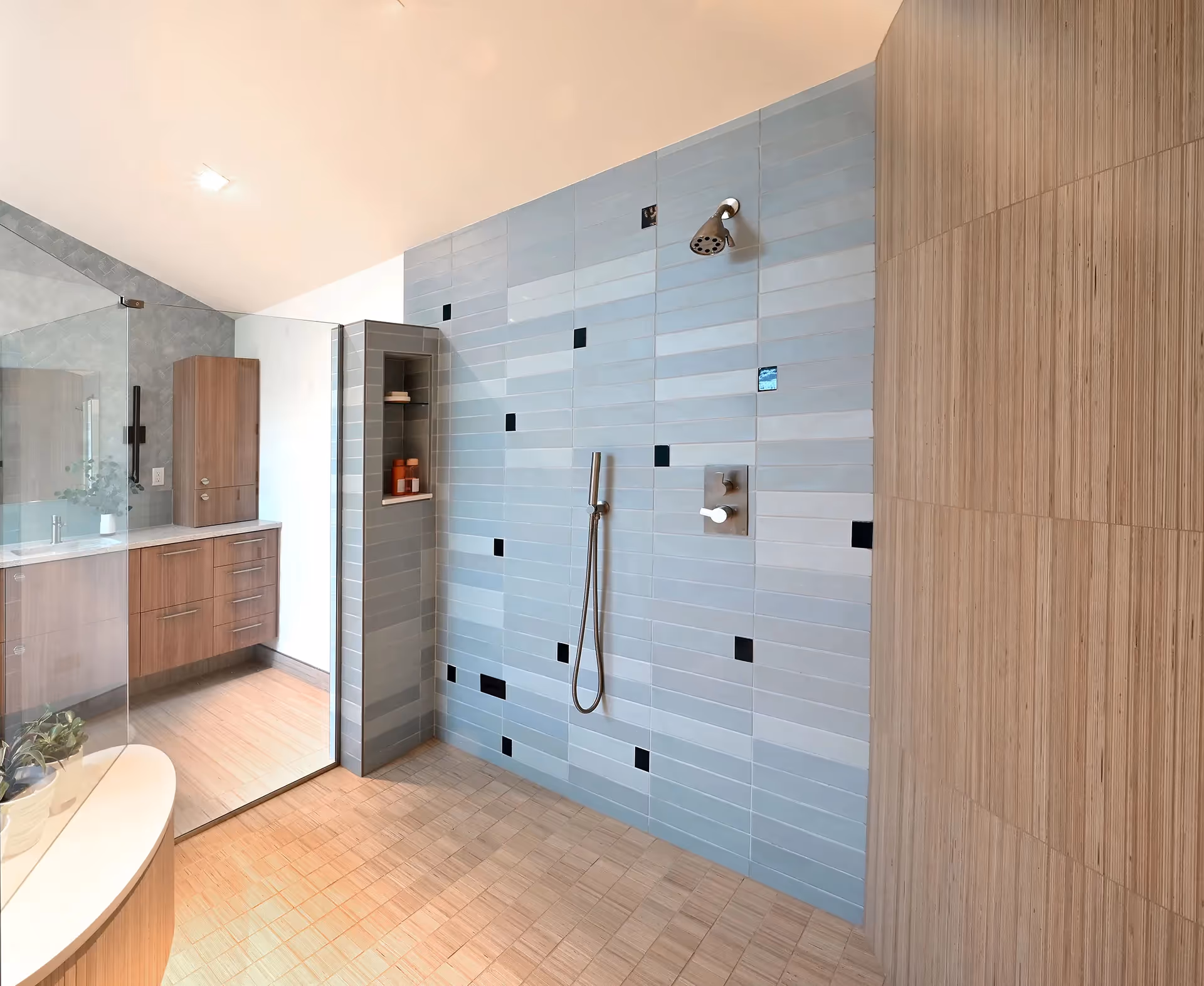 A nature-inspired master bath remodel on Mercer Island — stand-alone tub, his-and-her vanities, and panoramic water views through new horizontal windows.
