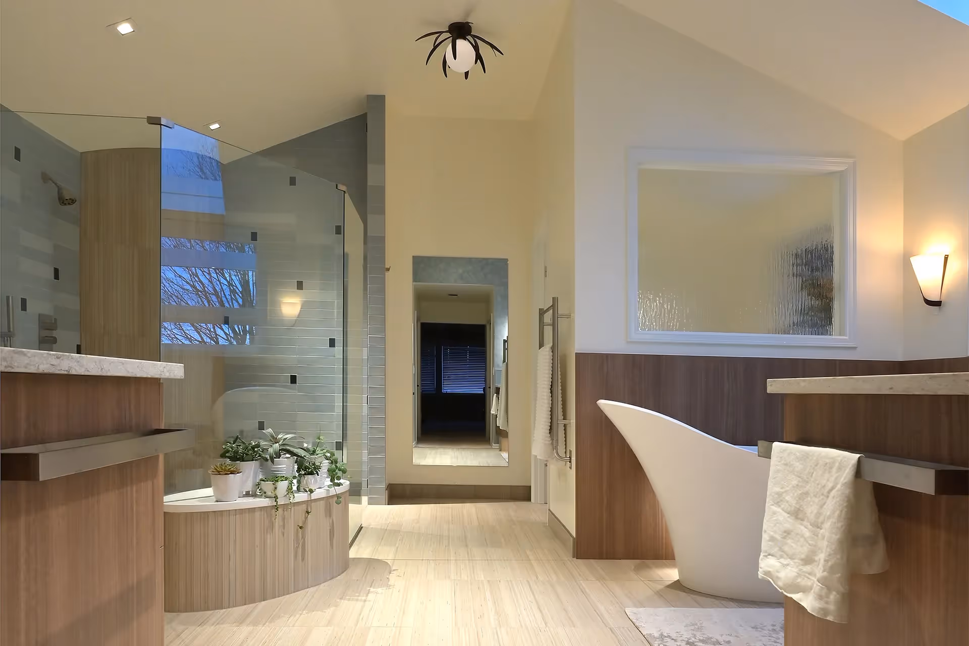 A nature-inspired master bath remodel on Mercer Island — stand-alone tub, his-and-her vanities, and panoramic water views through new horizontal windows.