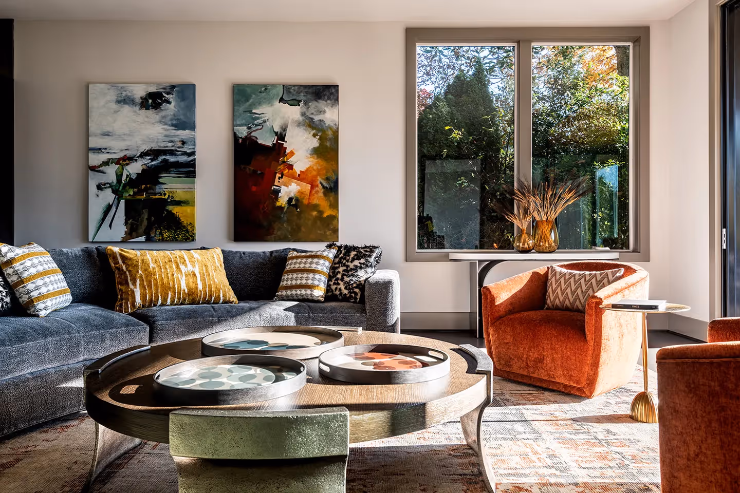 A whole-home transformation in Seattle's Magnolia neighborhood — living room, kitchen, deck, and dining room with sweeping water views and local art.