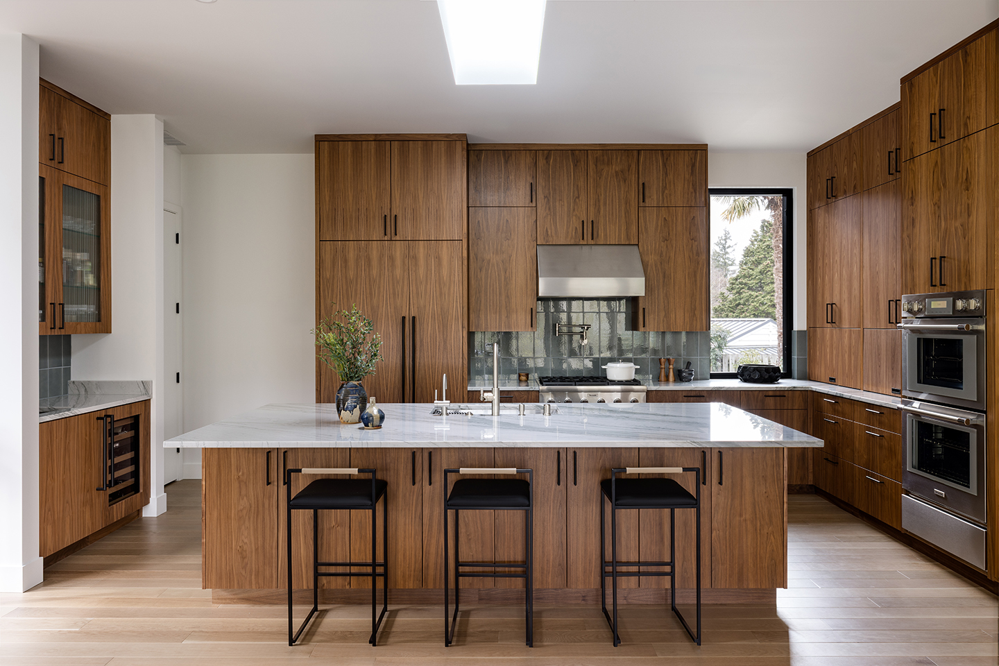 A Zen-inspired full remodel of a mid-century modern home in North Seattle — bookmatched cabinetry, quartzite countertops, and custom furnishings.