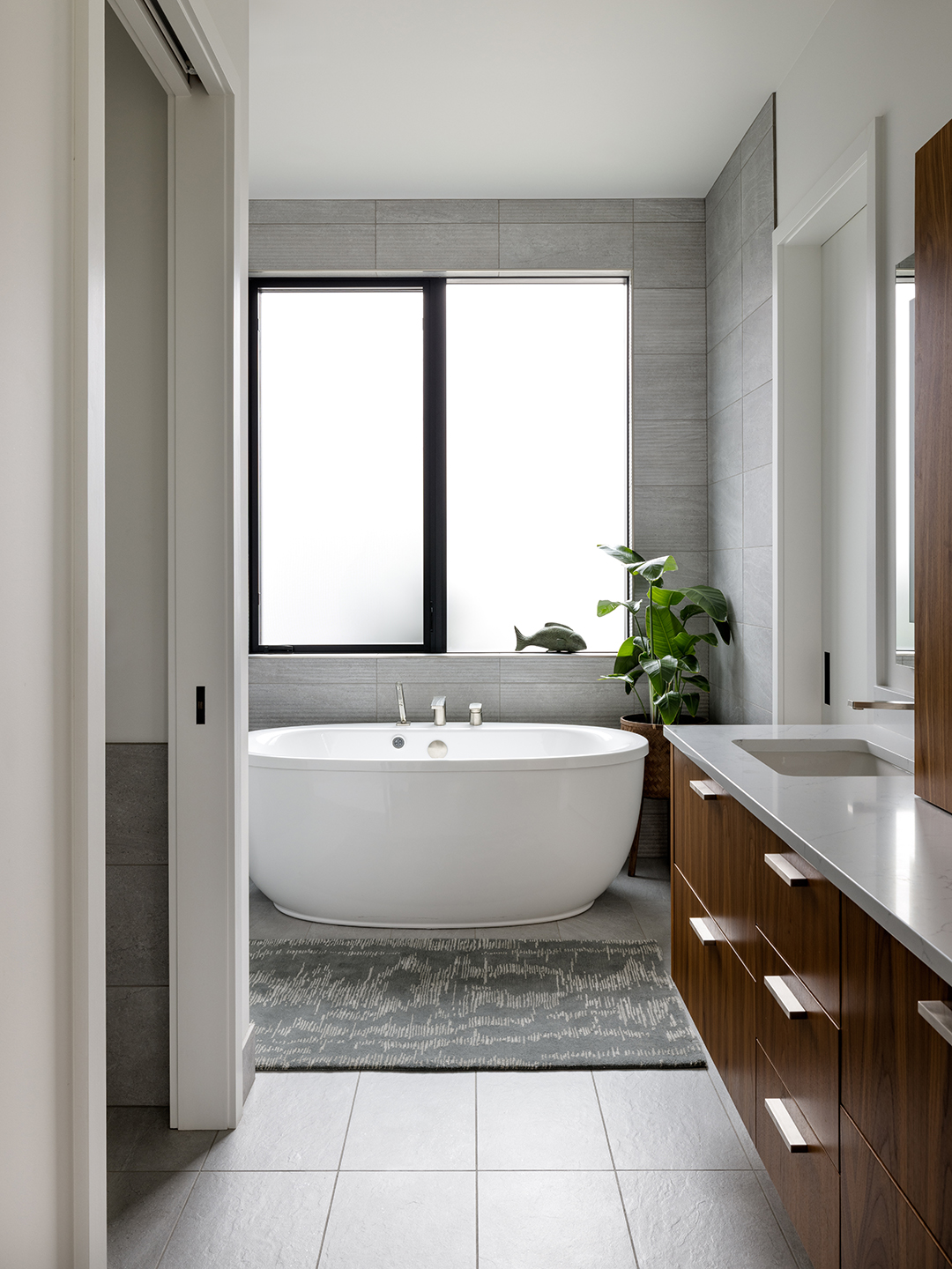 A Zen-inspired full remodel of a mid-century modern home in North Seattle — bookmatched cabinetry, quartzite countertops, and custom furnishings.