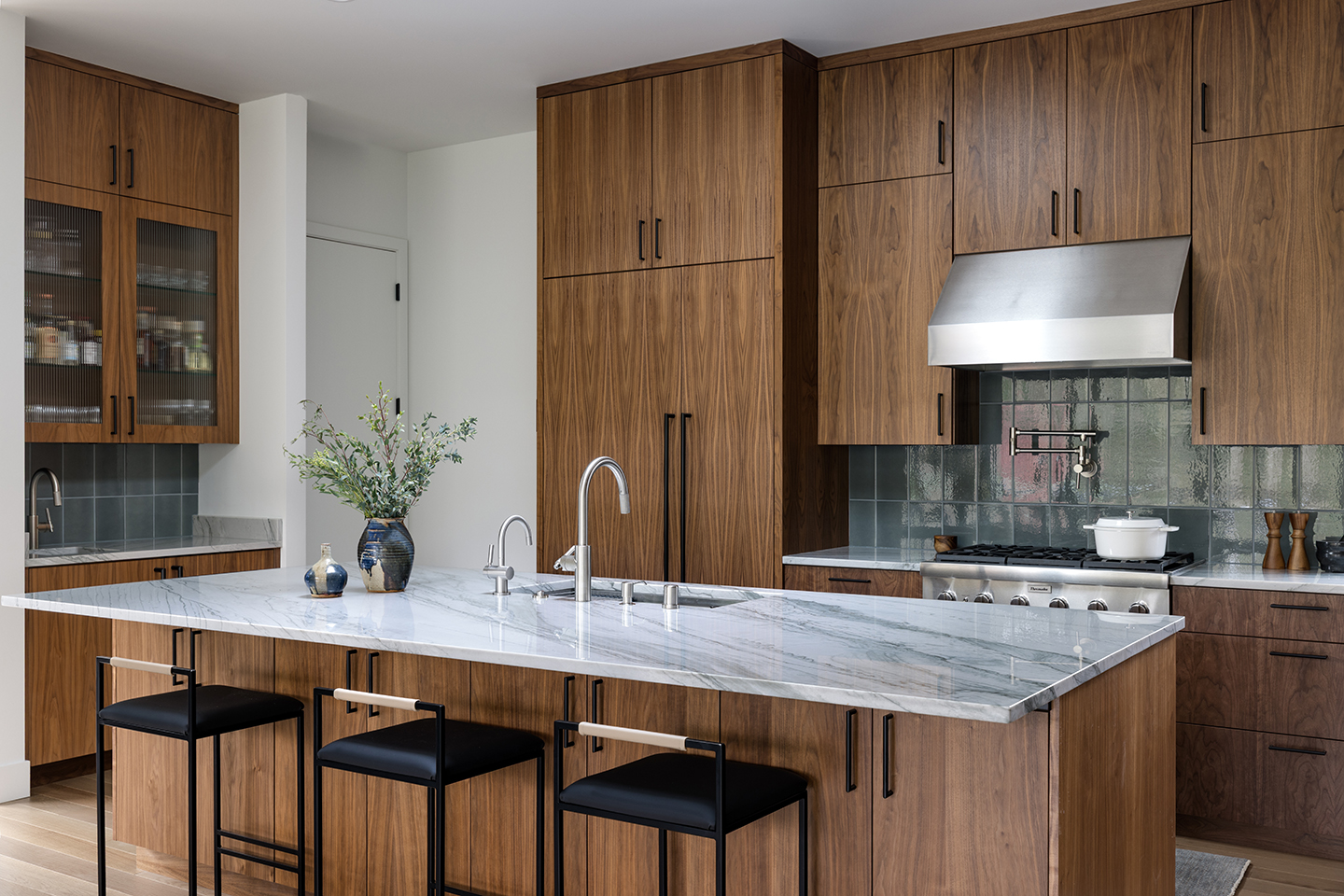 A Zen-inspired full remodel of a mid-century modern home in North Seattle — bookmatched cabinetry, quartzite countertops, and custom furnishings.