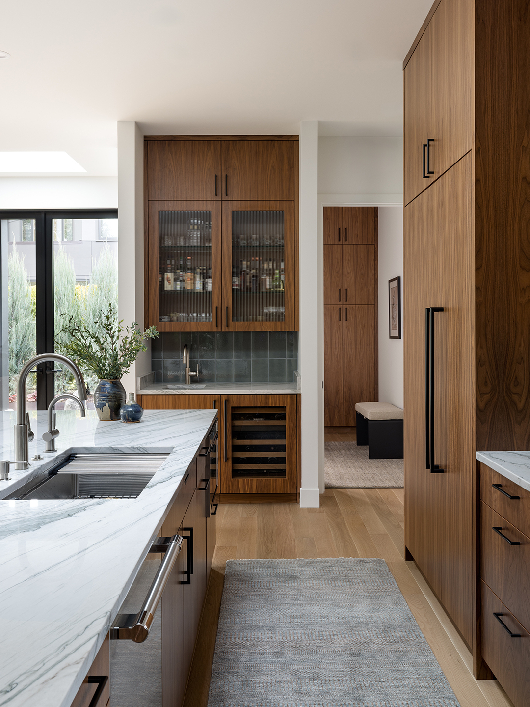 A Zen-inspired full remodel of a mid-century modern home in North Seattle — bookmatched cabinetry, quartzite countertops, and custom furnishings.