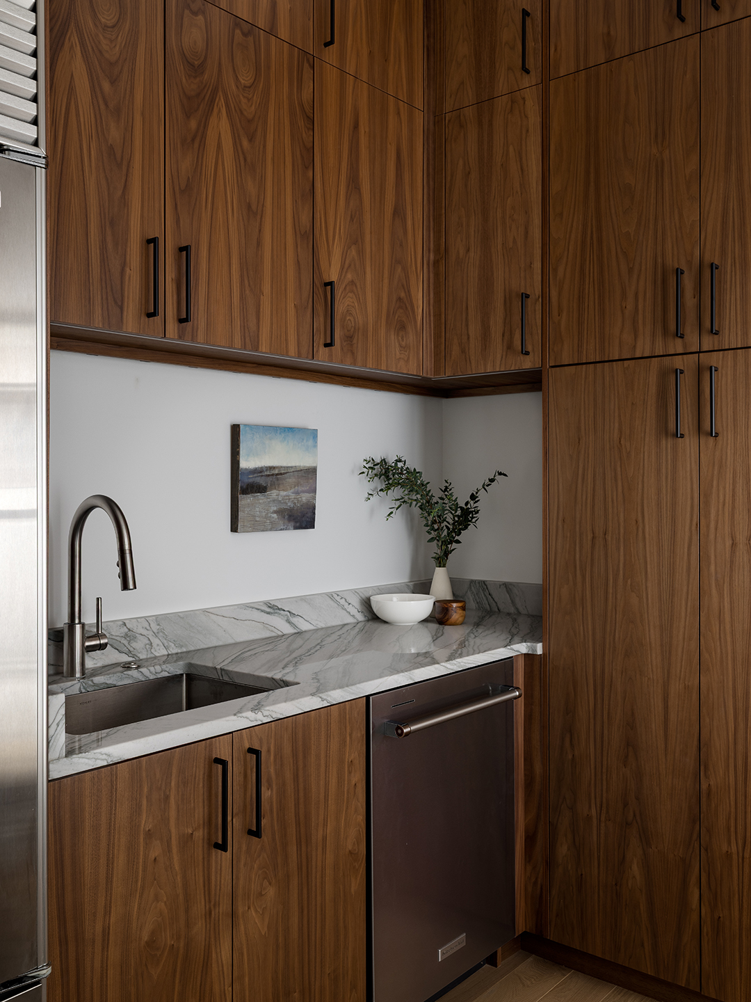 A Zen-inspired full remodel of a mid-century modern home in North Seattle — bookmatched cabinetry, quartzite countertops, and custom furnishings.