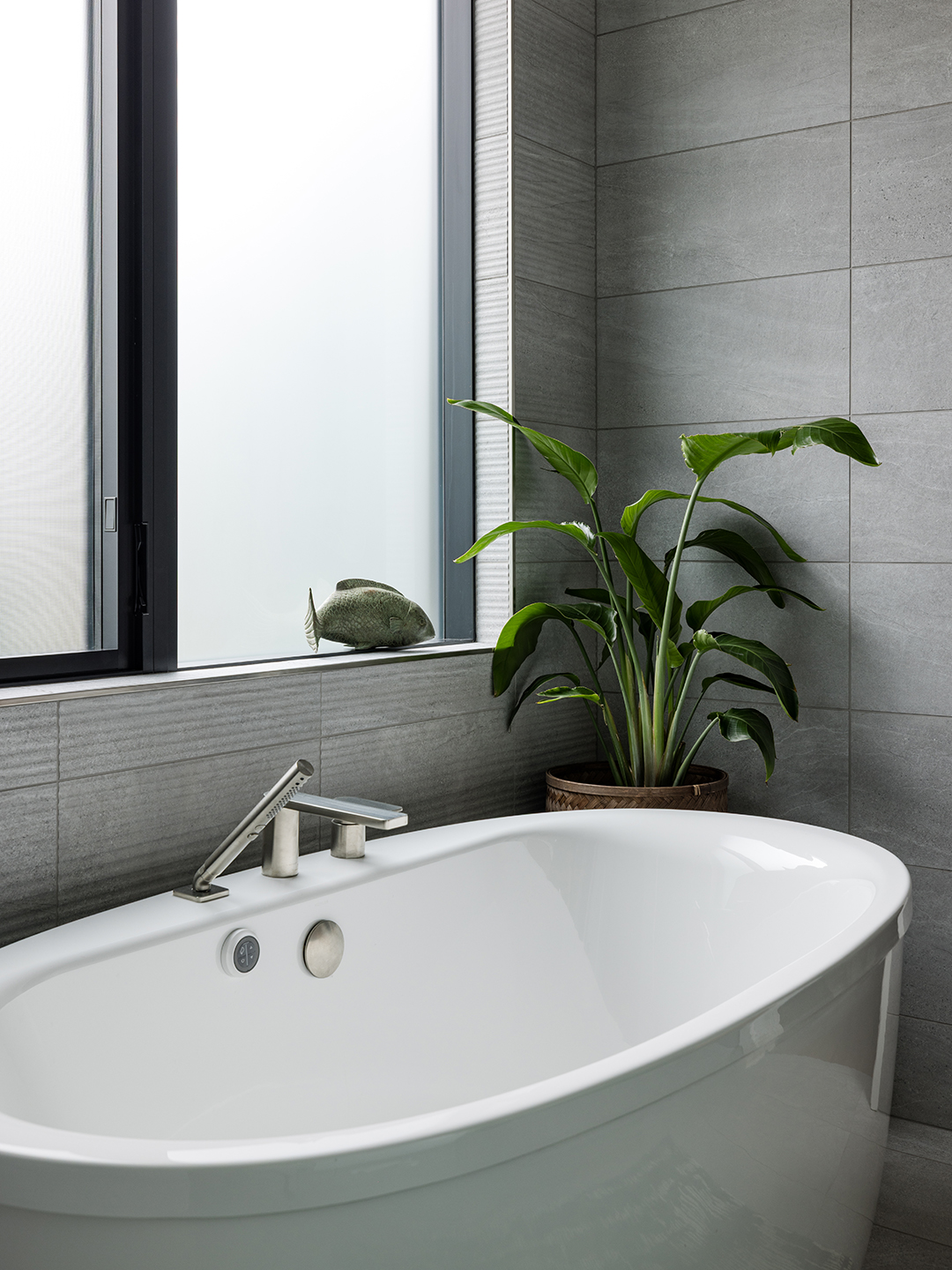 A Zen-inspired full remodel of a mid-century modern home in North Seattle — bookmatched cabinetry, quartzite countertops, and custom furnishings.