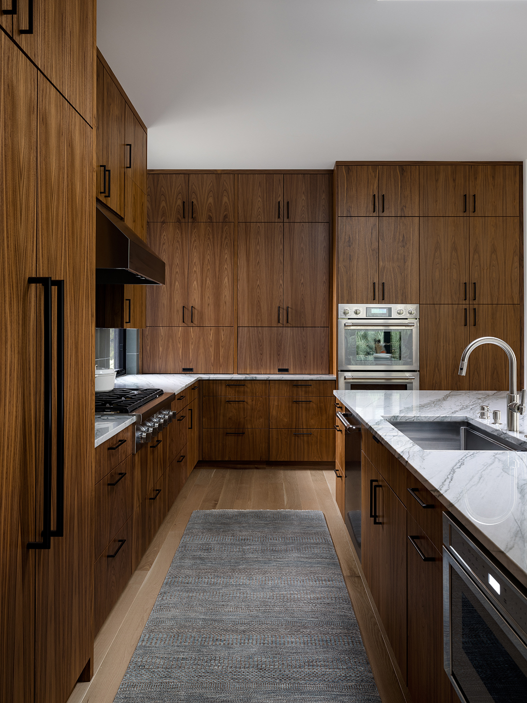 A Zen-inspired full remodel of a mid-century modern home in North Seattle — bookmatched cabinetry, quartzite countertops, and custom furnishings.