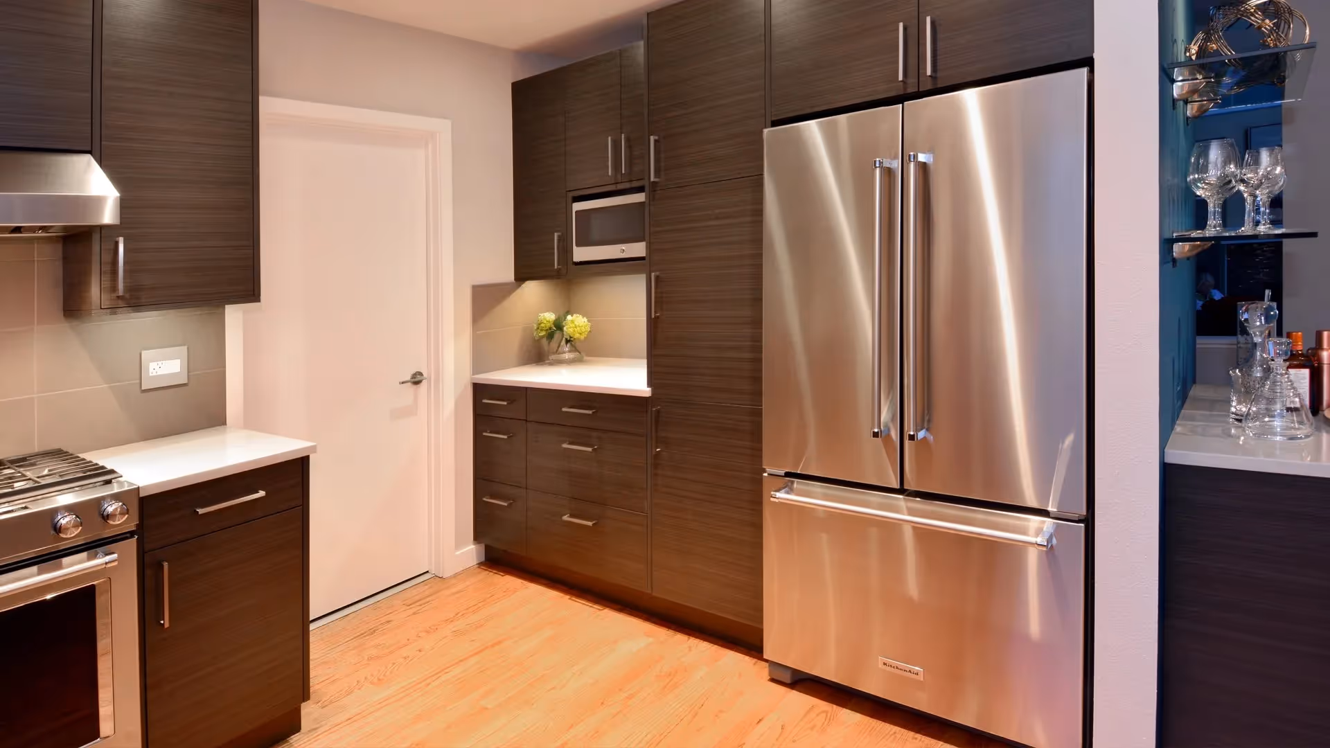 A Remodeling Excellence Award-winning kitchen and family room remodel in Mill Creek — open floorplan, wine storage, and a custom waterfall quartz table.