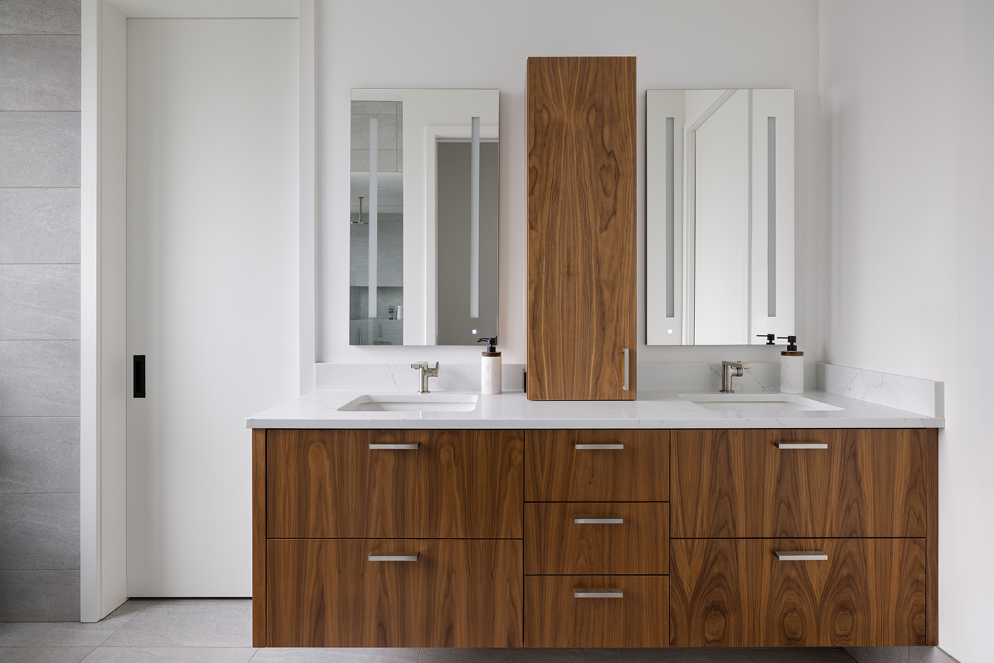 A Zen-inspired full remodel of a mid-century modern home in North Seattle — bookmatched cabinetry, quartzite countertops, and custom furnishings.