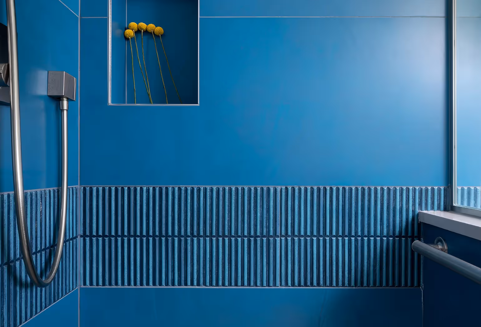 An award-winning guest bath in Sunset Hill, Seattle — ripple tile, vibrant wallcovering, and an NKBA 2023 Third Place recognition.