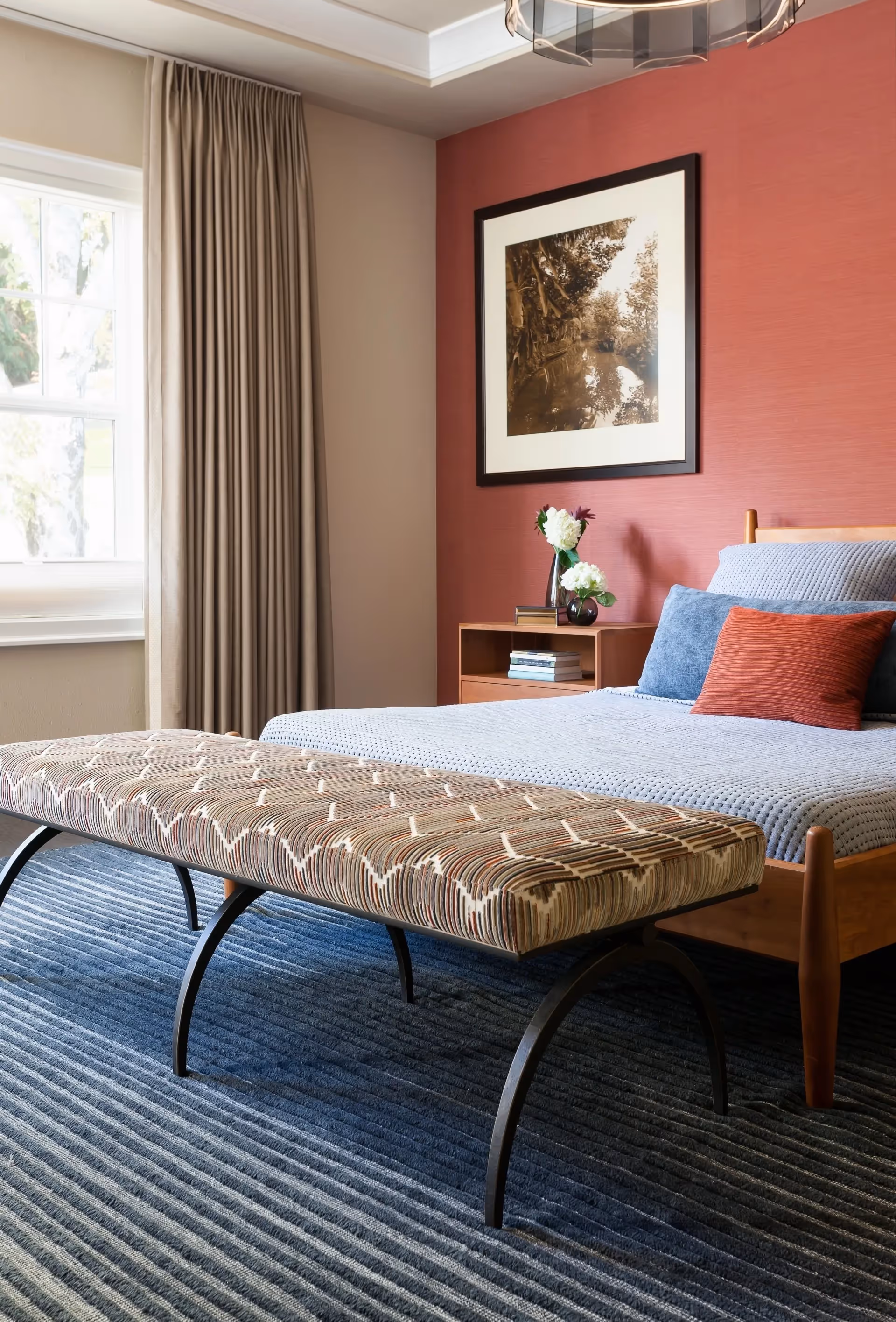 A bedroom redesign in Seattle's Laurelhurst neighborhood — jewel tones, sisal wallpaper, cut velvet, and a dramatic chandelier anchored by curated art.