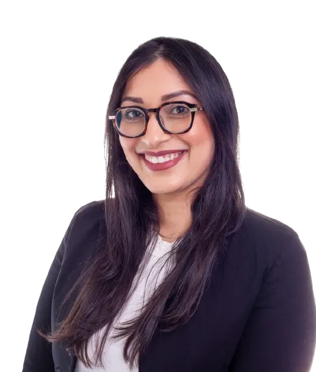 Smiling woman with long dark hair and glasses wearing a black blazer and white top.