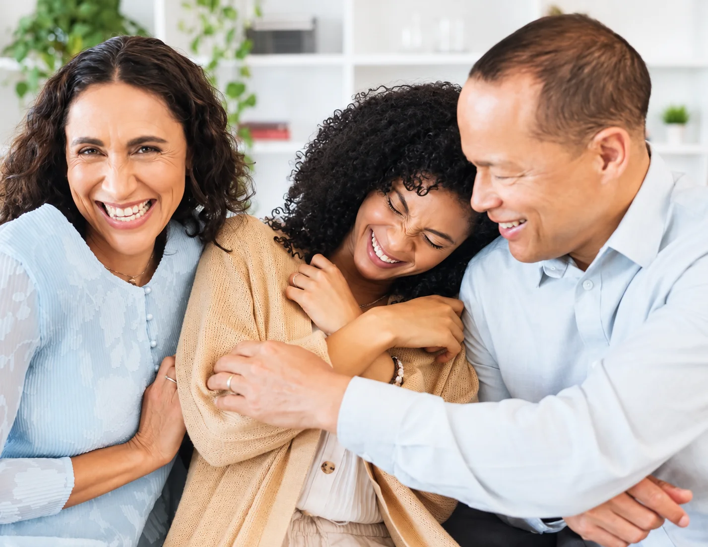A family sitting together in a therapy session, listening to one another.