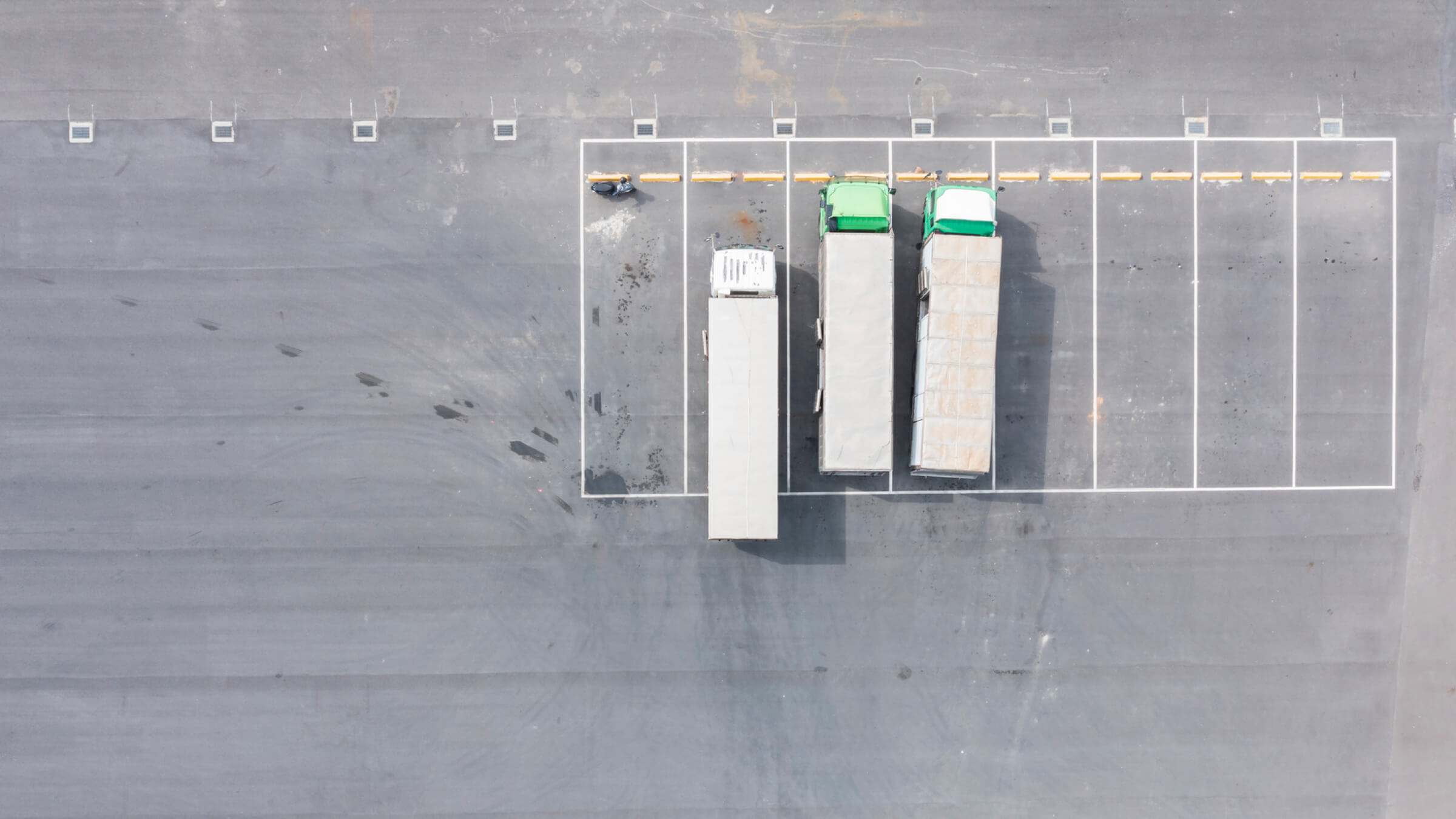 Delivery trucks pulling into a parking lot