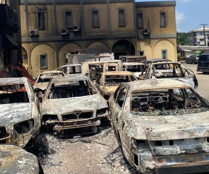 Fire-damaged vehicles and building after civil unrest