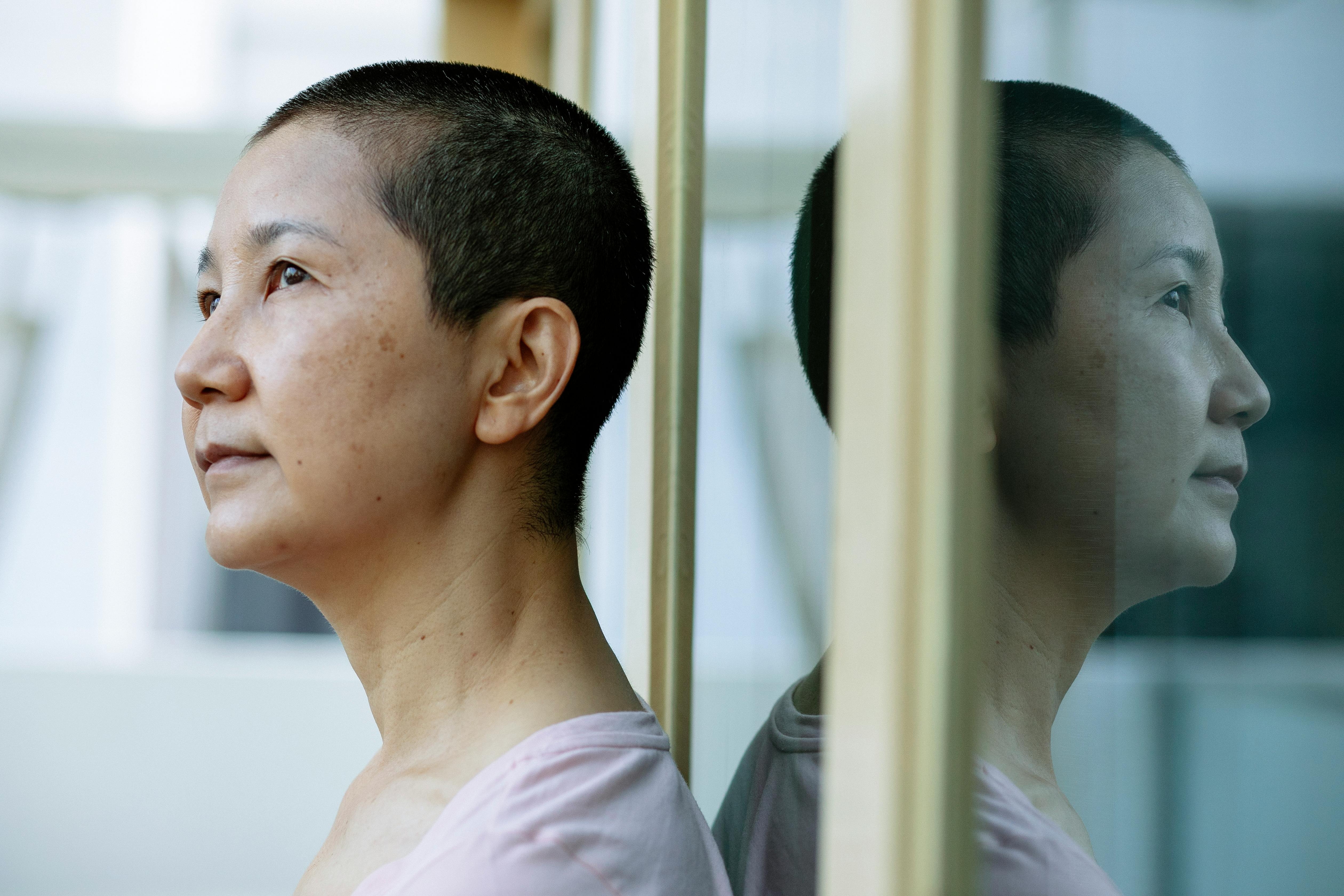 Middle age asian woman with shaved hair