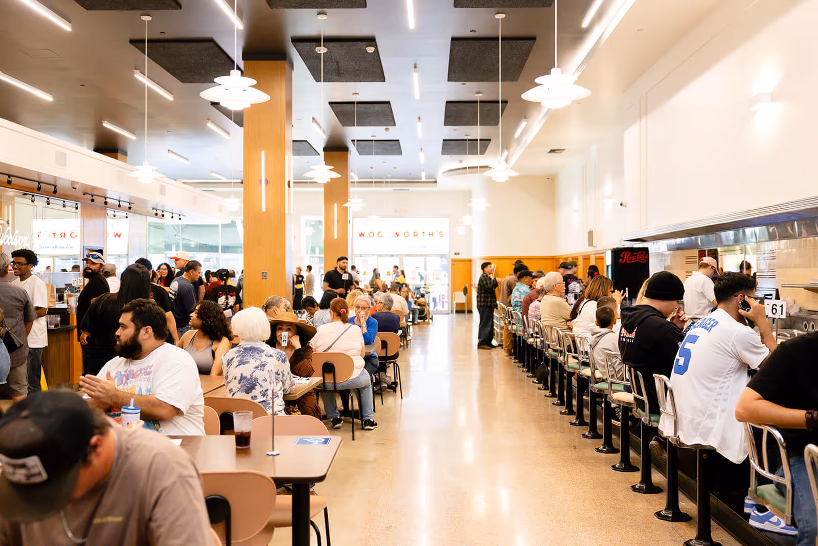 Architectural rendering inside the renovated Woolworth's Luncheonette with tables and chairs
