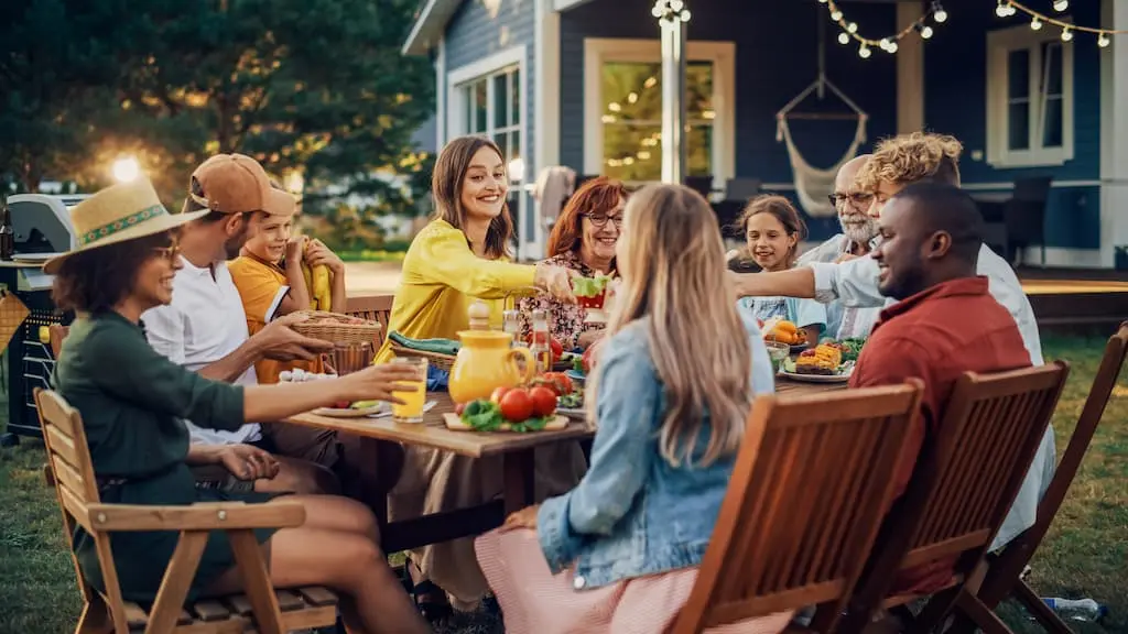Family and Friends Gathering Outside For Dinner