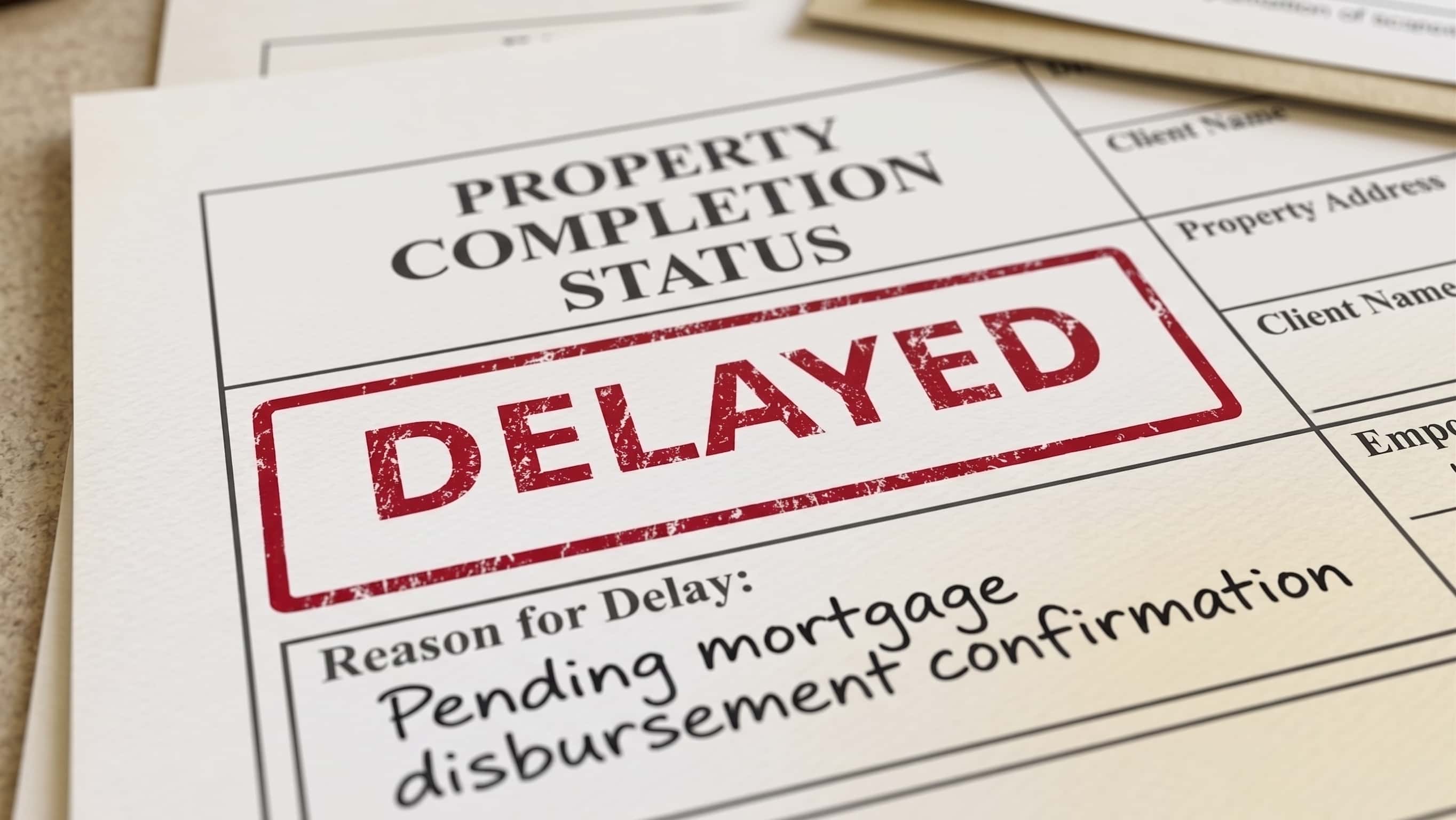 Delayed property completion notice stamped on a contract form