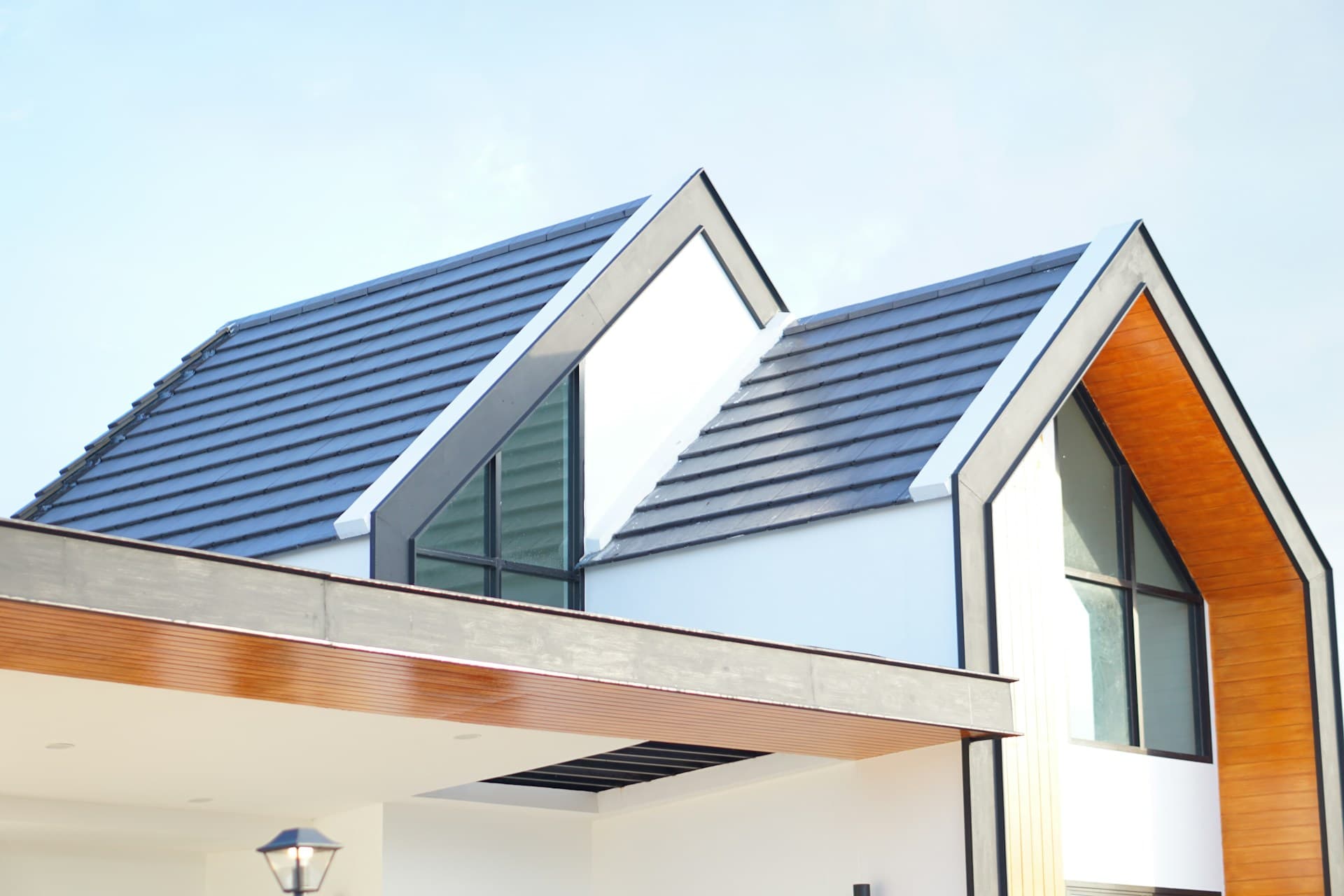 Modern new build home with pitched roofs and timber cladding
