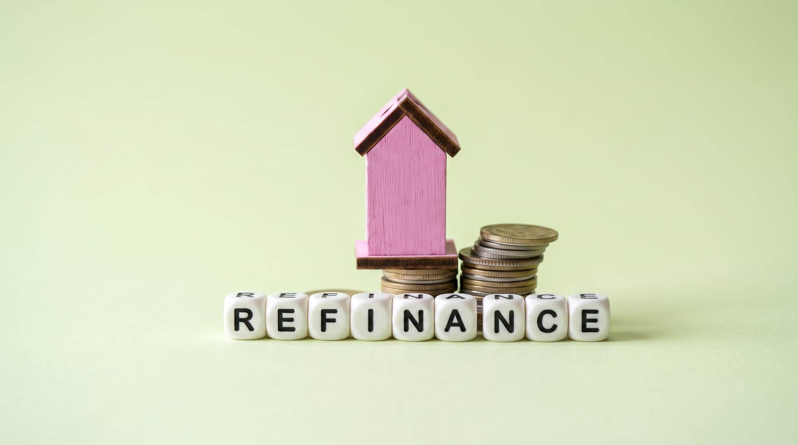 Model house on coins with beads spelling refinance